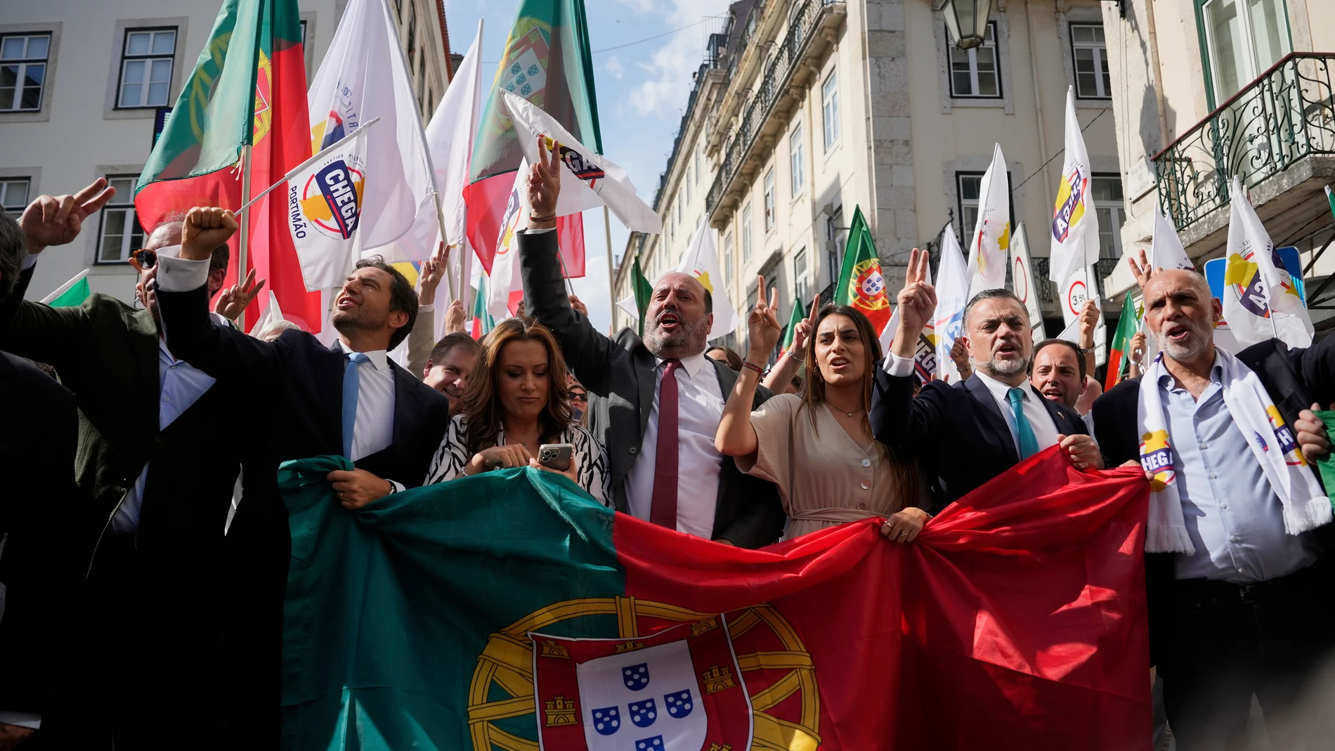Members of parliament of the populist right-wing party Chega carry a Portuguese flag during an election campaign rally in downtown Lisbon, Friday, May 16, 2025, ahead of the May 18 general election. (AP Photo/Ana Brigida)