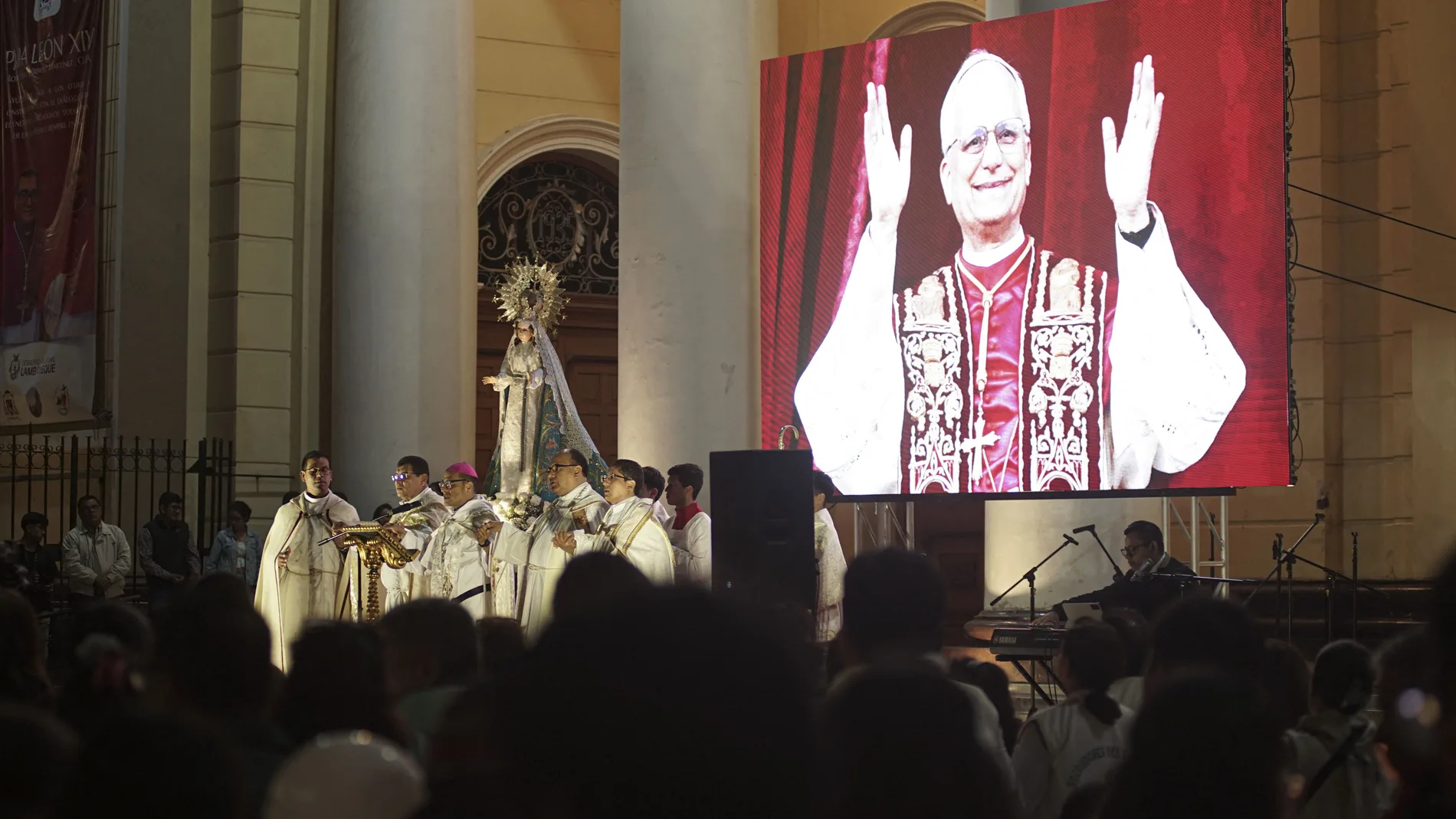 People participate in a vigil before a Holy Mass for the beginning of the Pontificate of Pope Leo XIV, in front of the Cathedral of Saint Mary in Chiclayo, Peru early on May 18, 2025. Ten days after the soft-spoken Robert Francis Prevost was chosen from among his fellow cardinals to lead the world's 1.4 billion Catholics, his papacy will formally begin in a ceremony at St Peter's Square