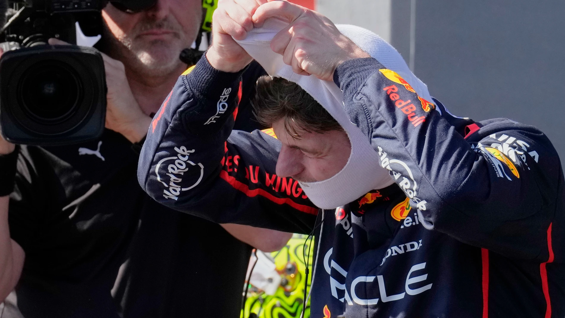 Red Bull driver Max Verstappen of the Netherlands removes his balaclava after winning the Italian Emilia Romagna Formula One Grand Prix, at the Enzo and Dino Ferrari racetrack in Imola, Italy, Sunday, May 18, 2025. (AP Photo/Luca Bruno)