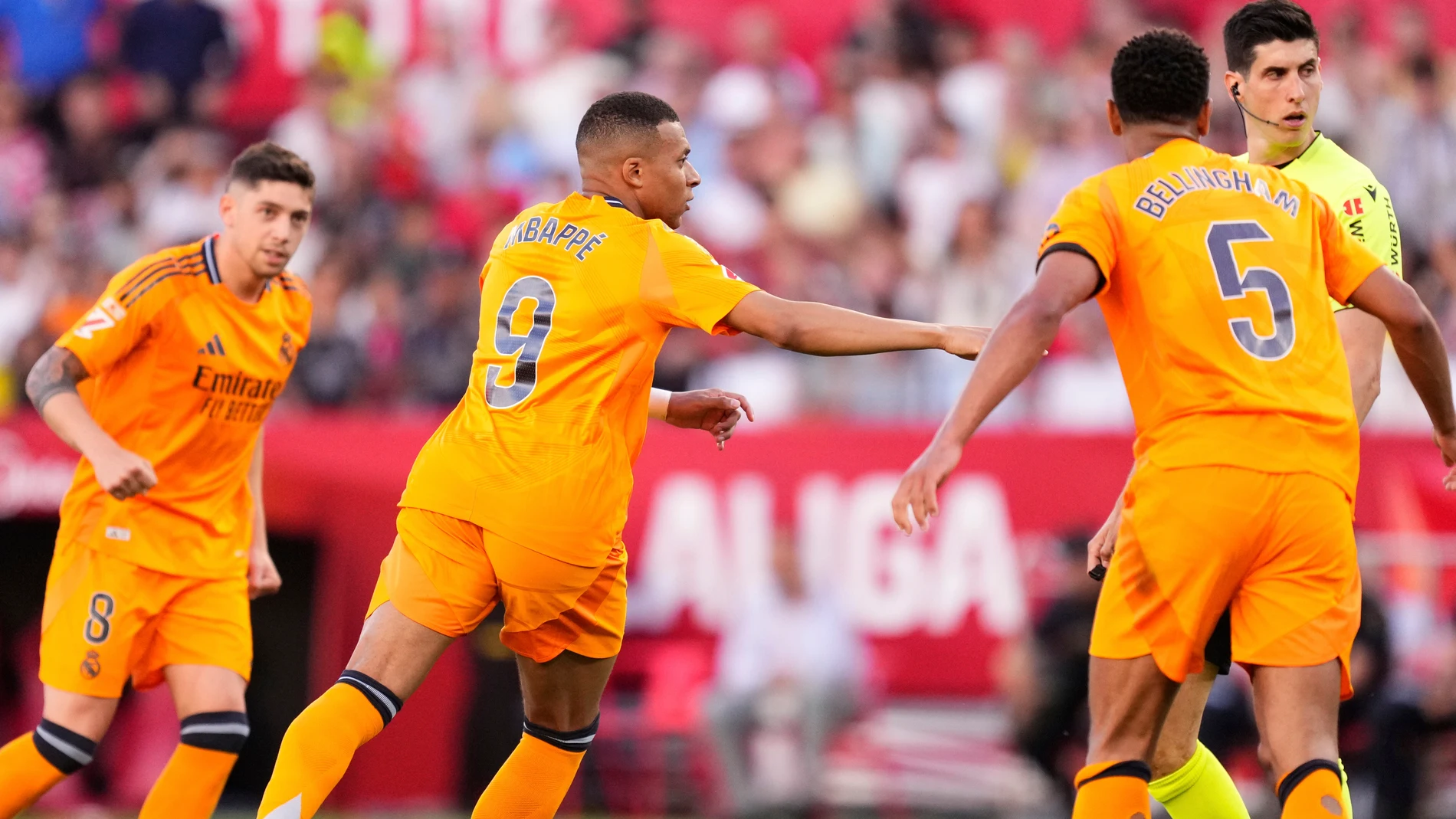 Real Madrid's Kylian Mbappe, centre, celebrates after scoring his side's opening goal during the Spanish La Liga soccer match between Sevilla and Real Madrid at the Ramon Sanchez Pizjuan stadium in Seville, Spain, Sunday, May 18, 2025. (AP Photo/Jose Breton)