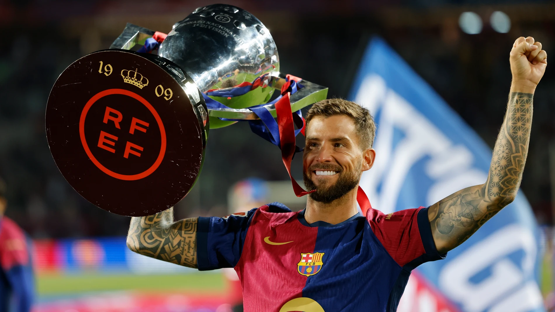 Barcelona's Inigo Martinez celebrates with the trophy after the Spanish La Liga soccer match between Barcelona and Villarreal at Lluis Companys Olympic Stadium in Barcelona, Spain, Sunday, May 18, 2025. (AP Photo/Joan Monfort)
