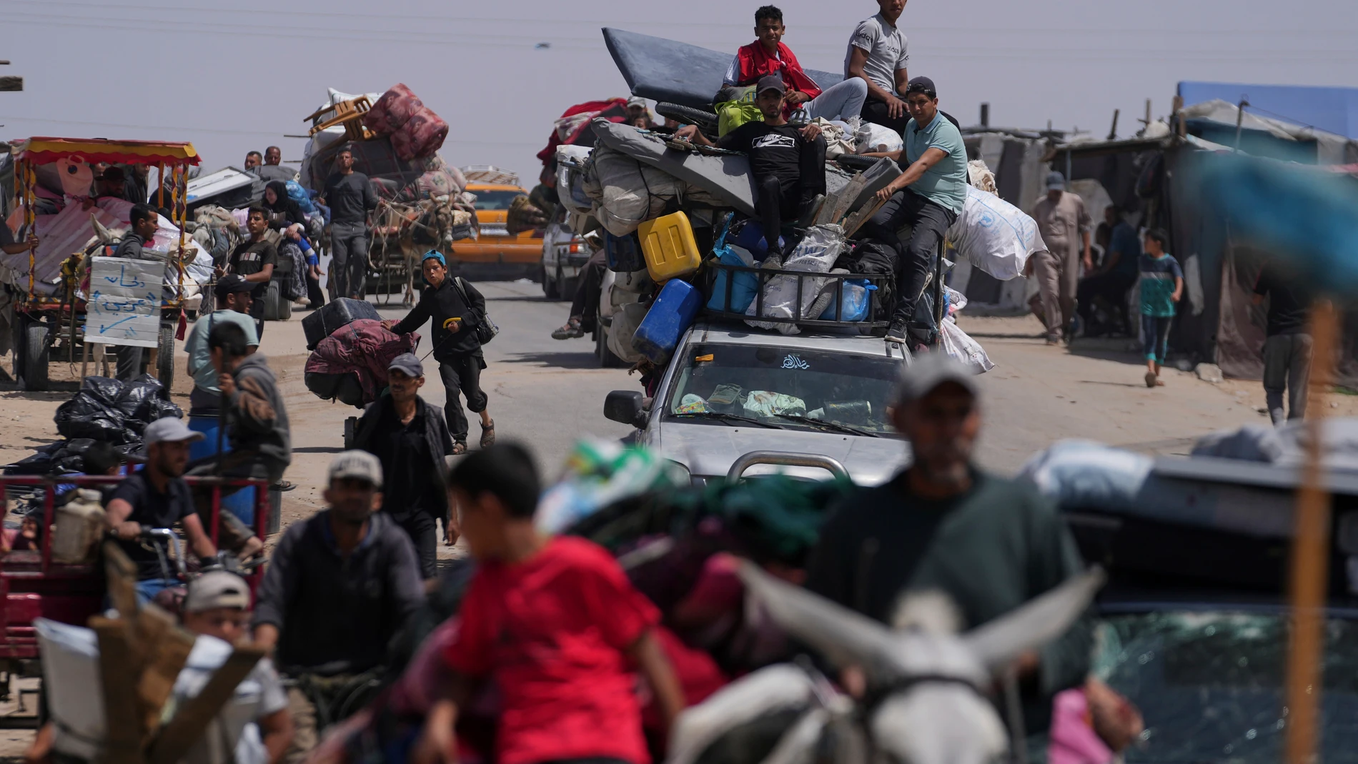 Displaced Palestinians flee from Khan Younis, Gaza, amid the ongoing Israeli military offensive in the area, on Monday, May 19, 2025. (AP Photo/Abdel Kareem Hana)