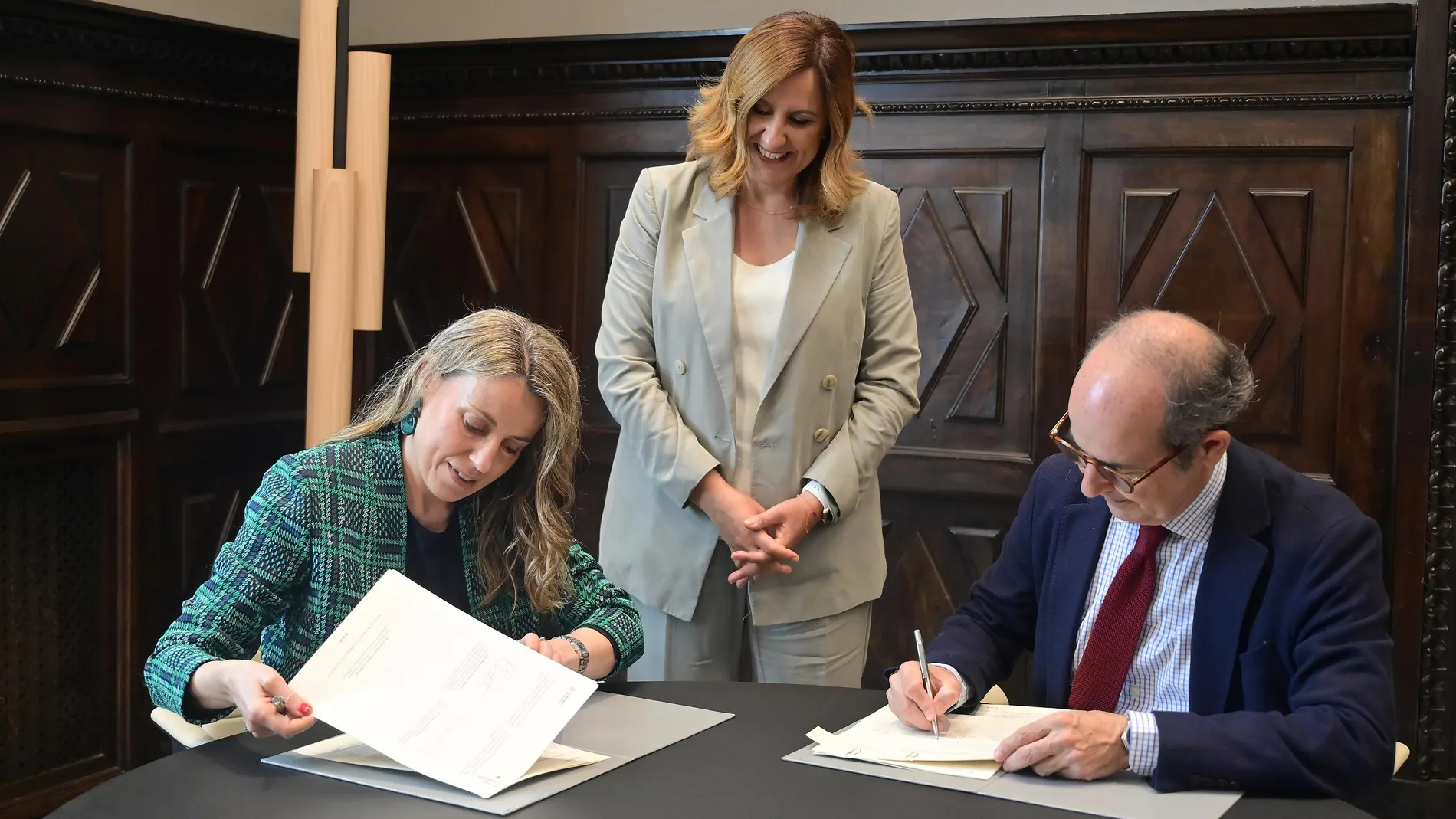 La concejal Julia Climent y el rector Higinio Marín, firman el convenio bajo la mirada de la alcaldesa, María José Catalá