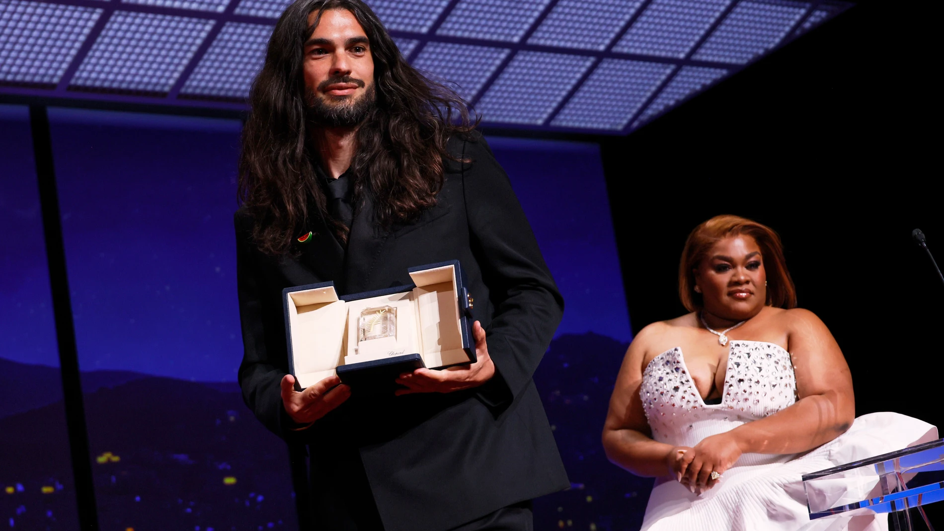 Director Oliver Laxe, left, accepts the jury prize for 'Sirat', presented by Da'Vine Joy Randolph, right, during the awards ceremony of the 78th international film festival, Cannes, southern France, Saturday, May 24, 2025. (Photo by Joel C Ryan/Invision/AP)