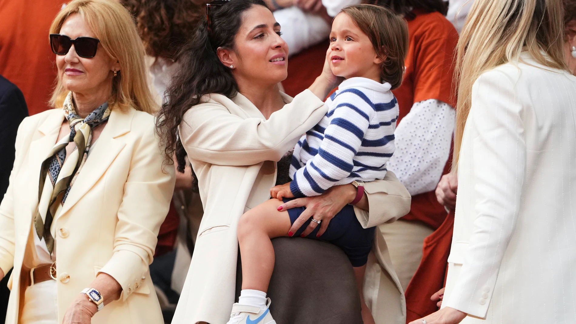Rafa Nadal's wife, Maria Francisca Perello, holds her son Rafael Junior, during a farewell ceremony at center court Philippe-Chatrier, at the Roland-Garros stadium, in Paris, Sunday May 25, 2025. (AP Photo/Lindsey Wasson)