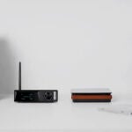 Dos altavoces estéreo de dos vías rodeando a un receptor Bluetooth integrado en un amplificador de Clase D
