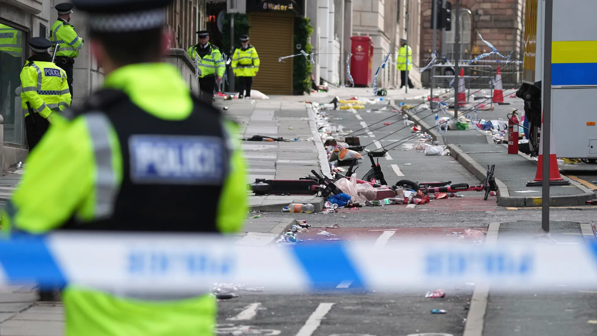 Police guards the site where a 53-year-old British man plowed a minivan into a crowd of Liverpool soccer fans who were celebrating the city's Premier League championship Monday, injuring more than 45 people in Liverpool, England, Tuesday, May 27, 2025.(AP Photo/Jon Super)