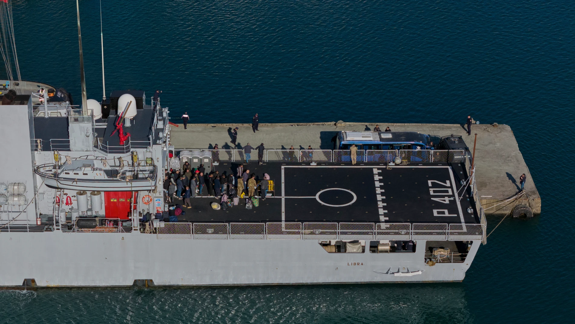 FILE - Migrants are waiting to disembarks the Italian navy ship Libra as Italian authorities transfer 40 migrants with no permission to remain in the country to Italian-run migration detention centers in Albania, in Shengjin, northwestern Albania, Friday, April 11, 2025. (AP Photo/Vlasov Sulaj, File)
