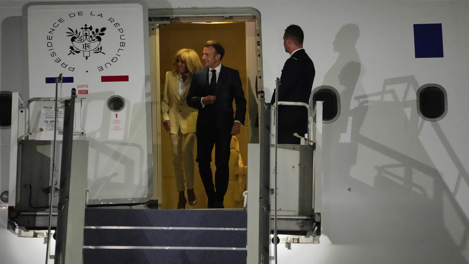 French President Emmanuel Macron and his wife Brigitte Macron disembark an aircraft upon arrival in Jakarta, Indonesia, Tuesday, May 27, 2025. (AP Photo/Achmad Ibrahim)