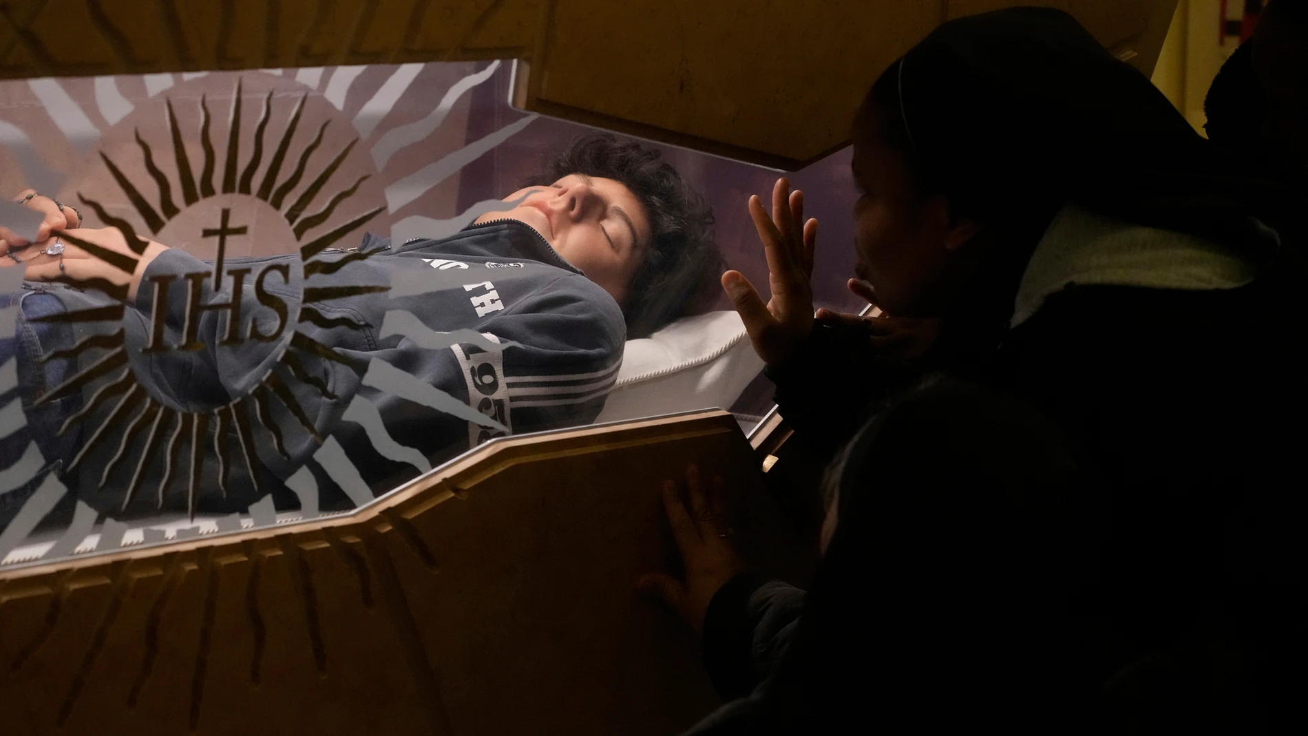 FILE - The body of Carlo Acutis, an Italian boy who died in 2006 of leukemia, lies in his tomb in Assisi, Italy, on Saturday, March 1, 2025. (AP Photo/Gregorio Borgia, file)