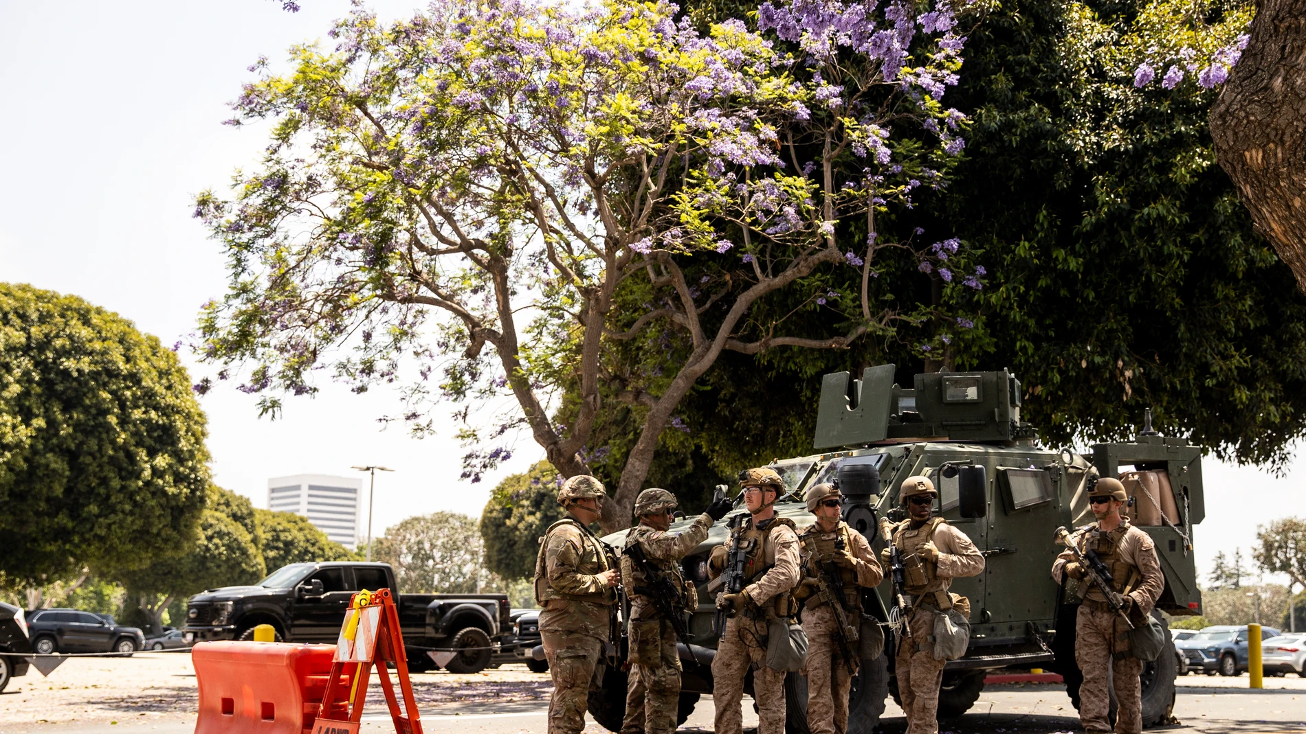 Members of the California National Guard and U.S. Marines, guard the entrance outside the Wilshire Federal Building, ahead of Saturday's nationwide "No Kings Day" protest, in Los Angeles, Calif., Friday, June 13, 2025. (Stephen Lam/San Francisco Chronicle via AP)