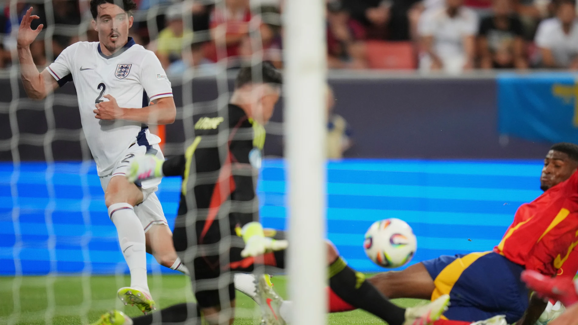 Spain's goalkeeper Alejandro Iturbe, center, makes a save in front of England's Tino Livramento, left, during a quarter final soccer match between Spain and England at the European U-21 Championship at the Anton Malatinsky Stadium, in Trnava, Slovakia, Saturday, June 21, 2025. (AP Photo/Petr David Josek)