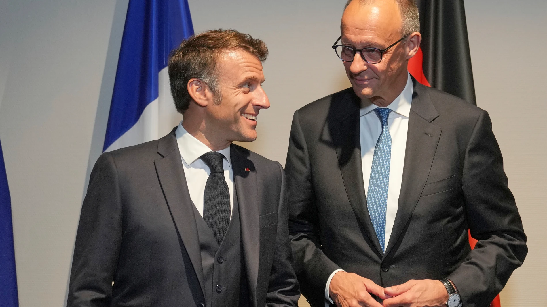French President Emmanuel Macron, left, with Germany's Chancellor Friedrich Merz, speak to each other during a media photocall ahead of an E3 meeting at a hotel on the sidelines of the NATO summit in The Hague, Netherlands, Tuesday, June 24, 2025. (AP Photo/Kin Cheung, Pool