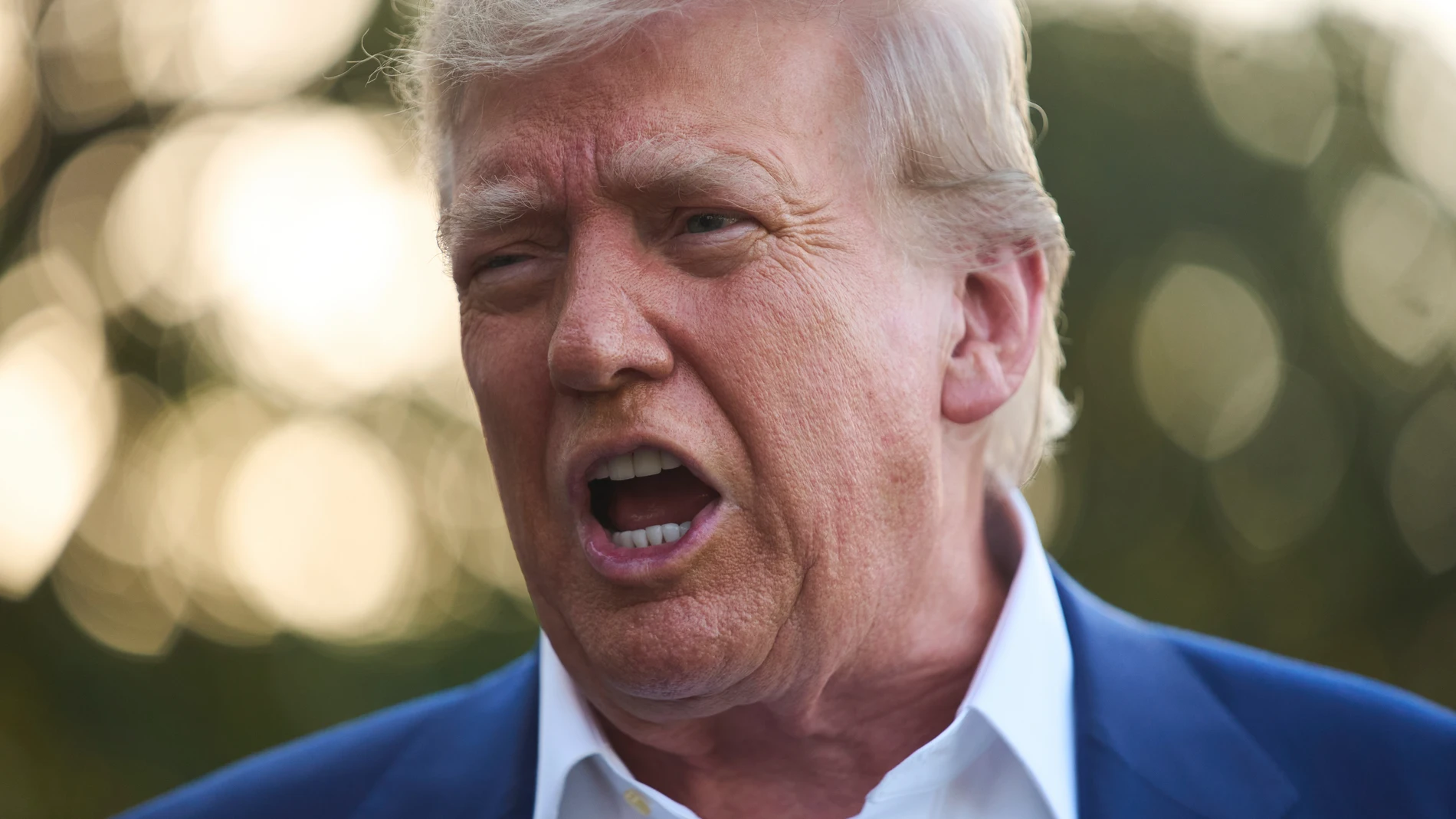 President Donald Trump speaks with reporters before boarding Marine One on the South Lawn of the White House, Tuesday, June 24, 2025, in Washington. (AP Photo/Evan Vucci)