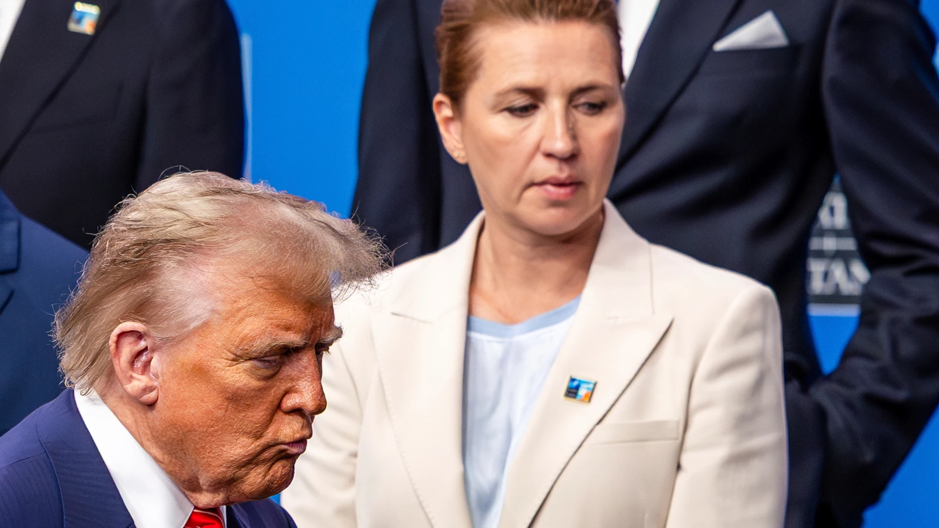 President Donald Trump, left, walks by Denmark's Prime Minister Mette Frederiksen prior to a group photo of NATO heads of state and government at the NATO summit in The Hague, Netherlands, Wednesday, June 25, 2025. (AP Photo/Geert Vanden Wijngaert)