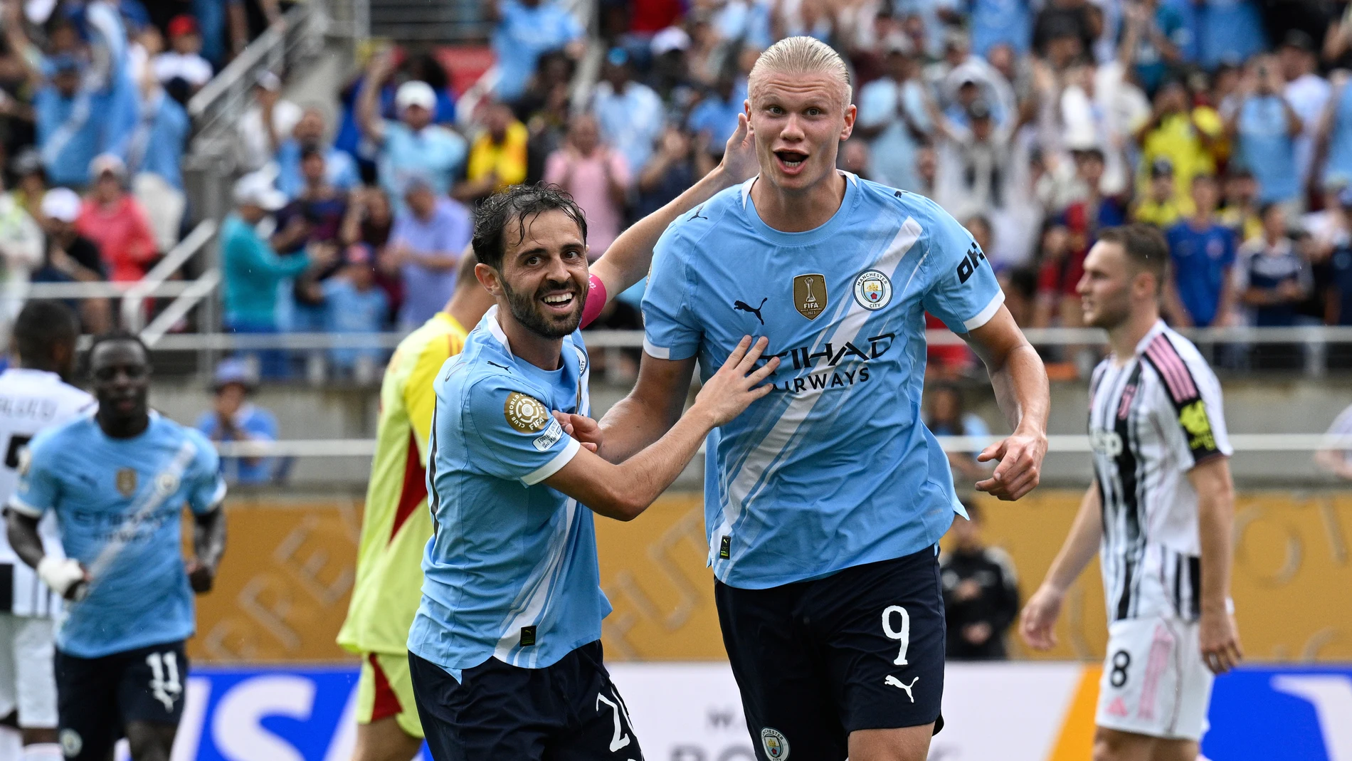 Manchester City's Erling Haaland, right, celebrates with teammate Bernardo Silva after scoring his side's third goal during the Club World Cup Group G soccer match between Juventus and Manchester City in Orlando, Fla., Thursday, June 26, 2025. (AP Photo/Phelan Ebenhack)
