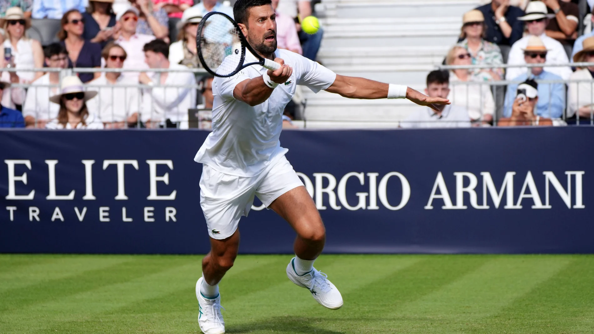 Novak Djokovic hits a volley against Karen Khachanov during the Giorgio Armani Tennis Classic at The Hurlingham Club, Friday, June 27, 2025, in London. (Jonathan Brady/PA via AP)