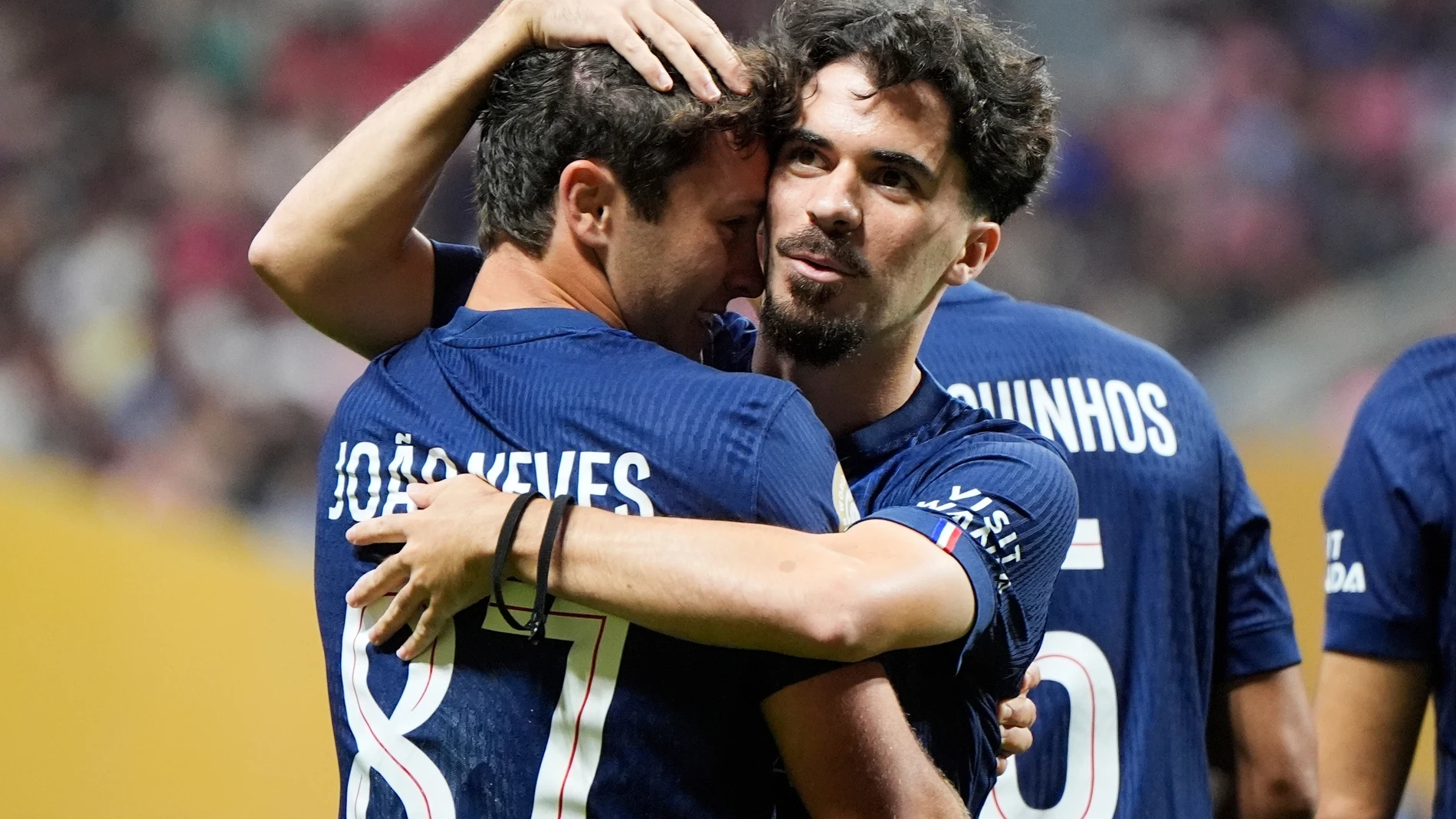 Paris Saint-Germain's Joao Neves, left, embraces Paris Saint-Germain's Vitinha after Neves scored his team's opening goal during the Club World Cup round of 16 soccer match between PSG and Inter Miami in Atlanta, Sunday, June 29, 2025. (AP Photo/Mike Stewart)