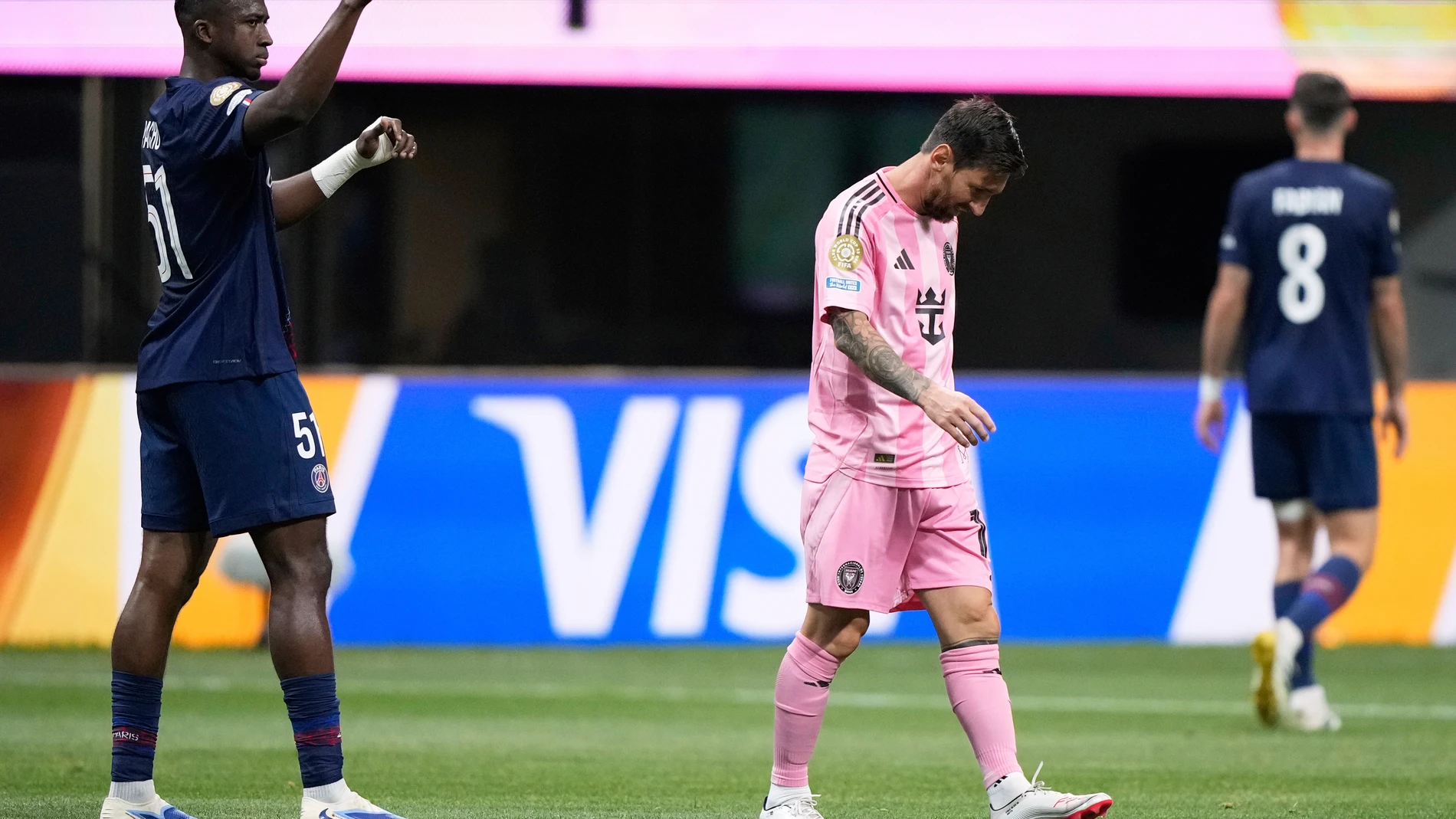 Paris Saint-Germain's Willian Pacho, left, signals as Inter Miami's Lionel Messi, center, walks away during the Club World Cup round of 16 soccer match between PSG and Inter Miami in Atlanta, Sunday, June 29, 2025. (AP Photo/Brynn Anderson)