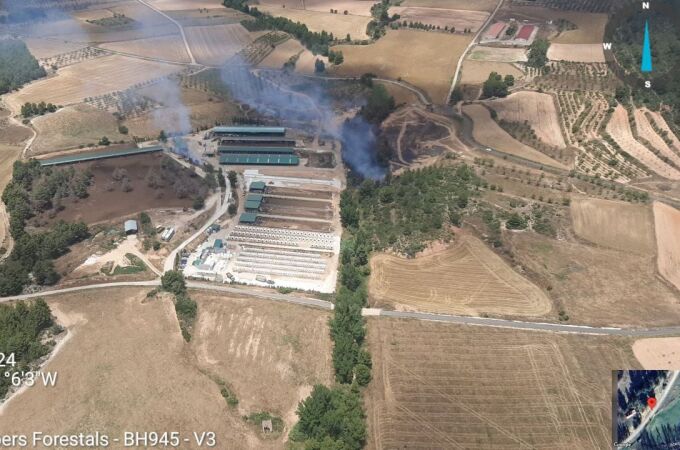 Los bomberos luchan contra el fuego en un incendio forestal en Titaguas