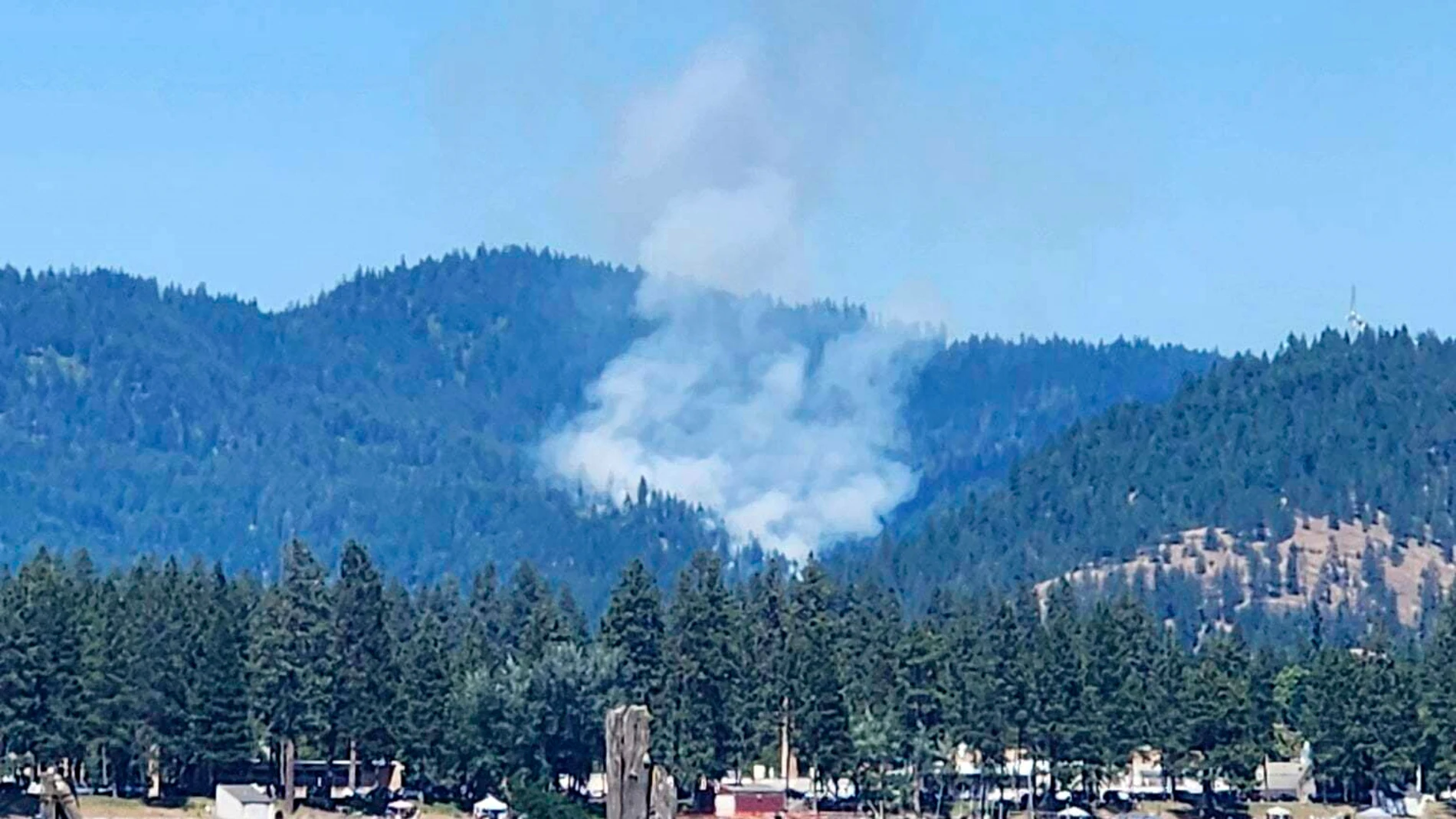 Smoke rises from a fire near Coeur d'Alene, Idaho, where responding firefighters were shot on Sunday, June 29, 2025. (Bruce Deming via AP)