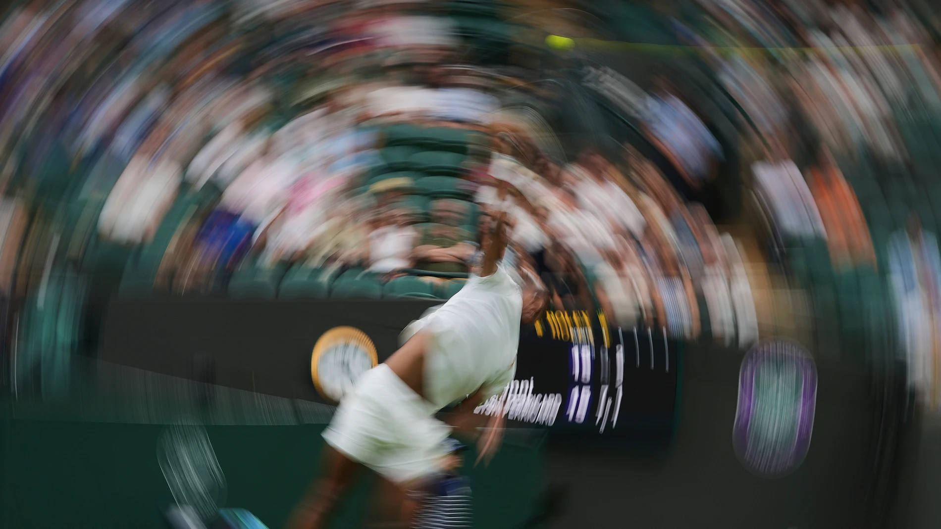 Giovanni Mpetshi Perricard of France returns the ball to Taylor Fritz of the U.S. during their first round women's single match at the Wimbledon Tennis Championships in London, Monday, June 30, 2025. (AP Photo/Kin Cheung)