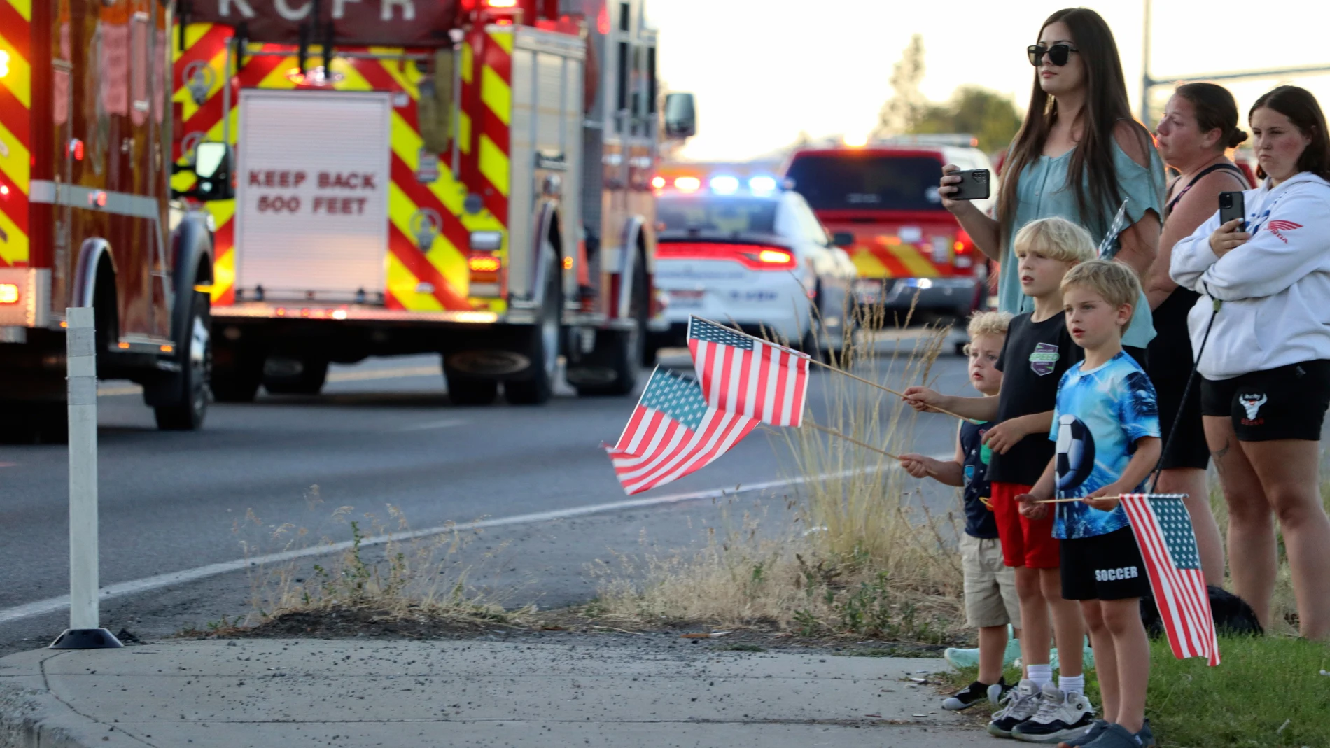 A procession from Kootenai Health headed to Spokane after a few firefighters were killed Sunday, June 29, 2025, when they were ambushed by sniper fire while responding to a blaze in a northern Idaho mountain community, in Coeur d’Alene, Idaho. (Bill Buley/Coeur D'Alene Press via AP)