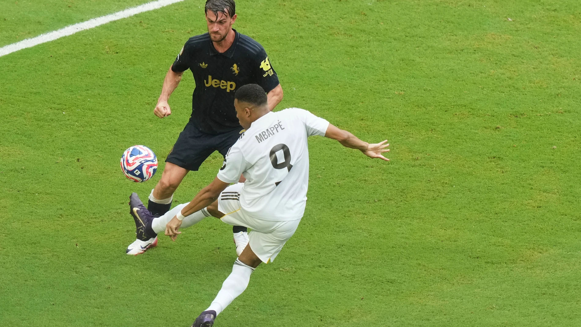 Real Madrid's Kylian Mbappe (9) controls the ball as Juventus' Daniele Rugani (24) defend during the Club World Cup round of 16 soccer match between Real Madrid and Juventus in Miami Gardens, Fla., Tuesday, July 1, 2025. (AP Photo/Marta Lavandier)