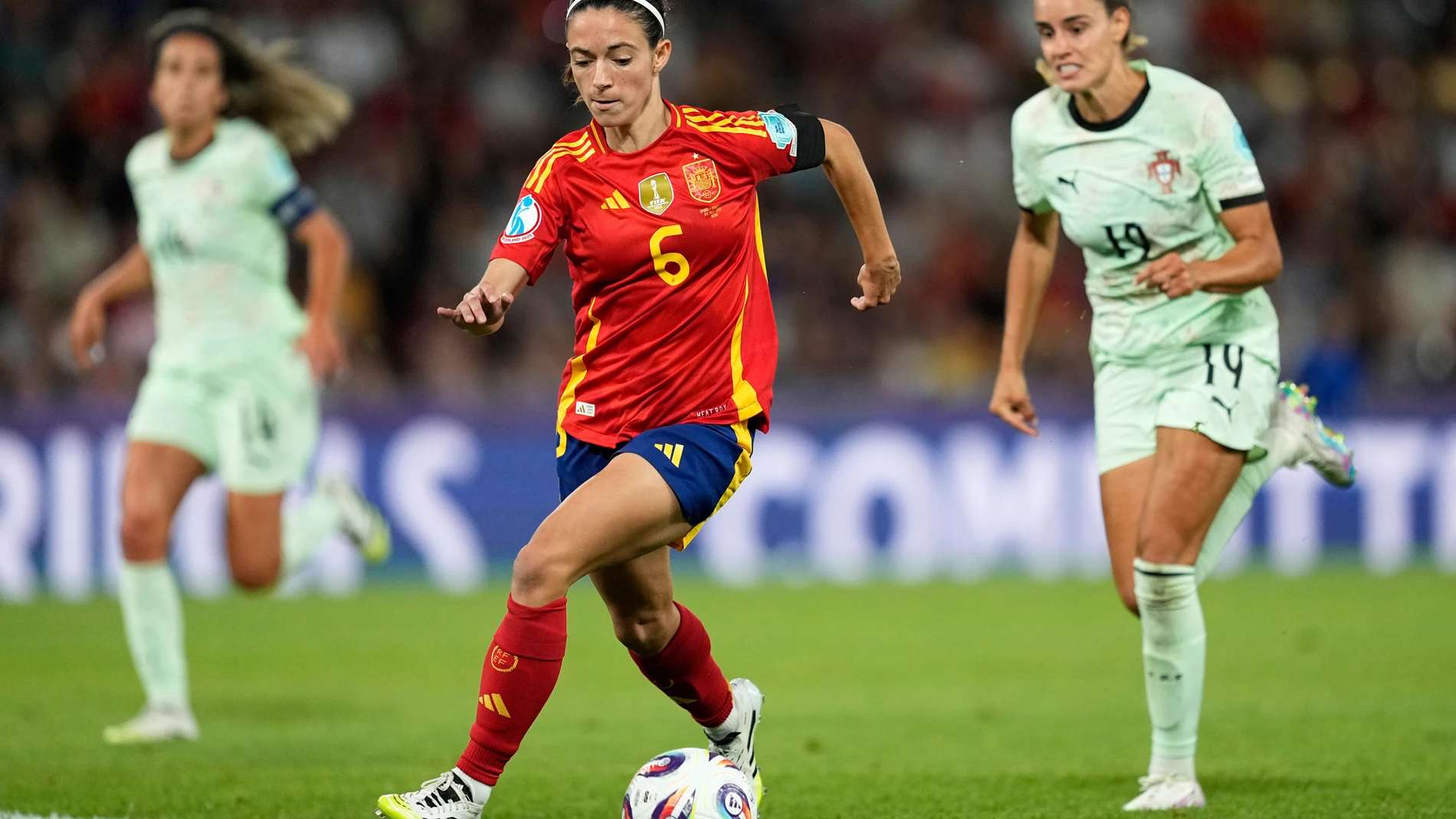 Spain's Aitana Bonmati runs with the ball followed by Portugal's Diana Gomes, right, during the Euro 2025, group B, soccer match between Spain and Portugal at Stadion Wankdorf in Bern, Switzerland, Thursday, July 3, 2025. (AP Photo/Martin Meissner)