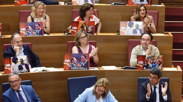 Los diputados del PP exhiben carteles de 'Gobierno corrupto' en Les Corts y el PSPV replica: "Faltan Zaplana y Mazón"