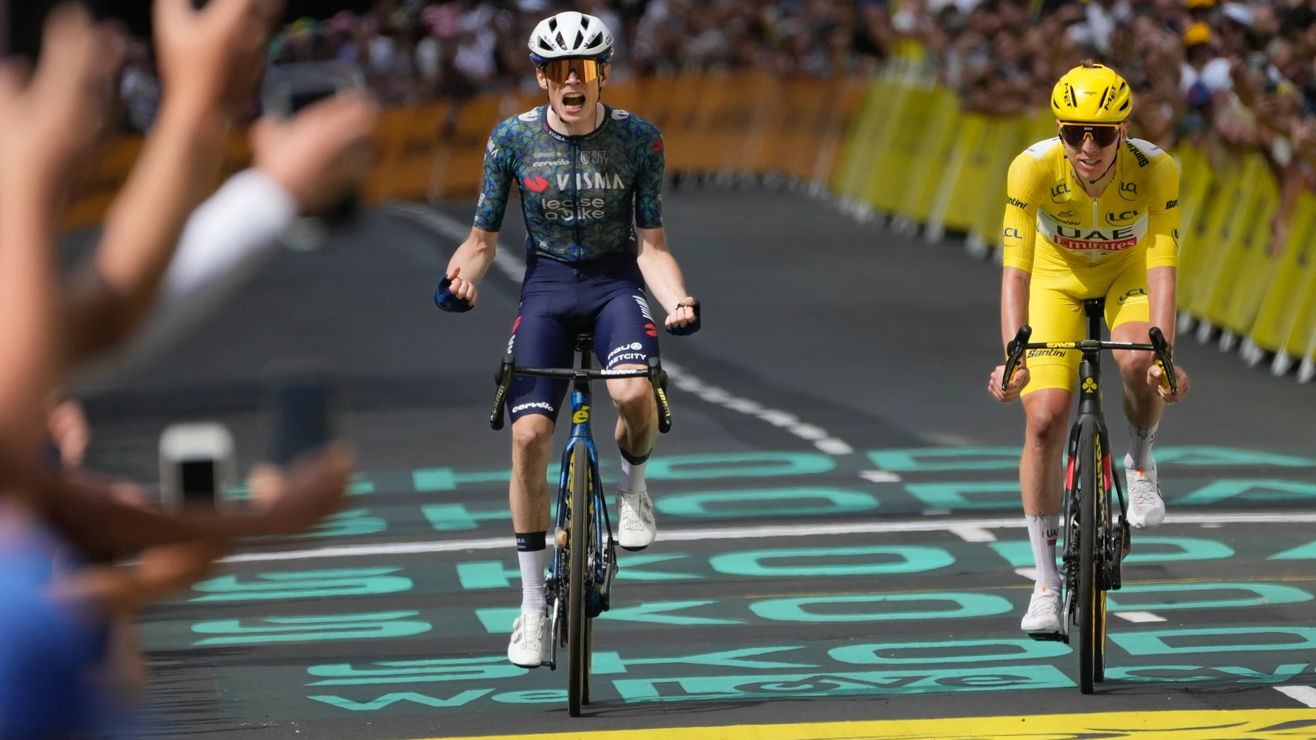 FILE - Denmark's Jonas Vingegaard celebrates as he crosses the finish line ahead of Slovenia's Tadej Pogacar, wearing the overall leader's yellow jersey, to win the eleventh stage of the Tour de France cycling race over 211 kilometers (131.1 miles) with start in Evaux-les-Bains and finish in Le Lorian, France, Wednesday, July 10, 2024. (AP Photo/Jerome Delay, File)