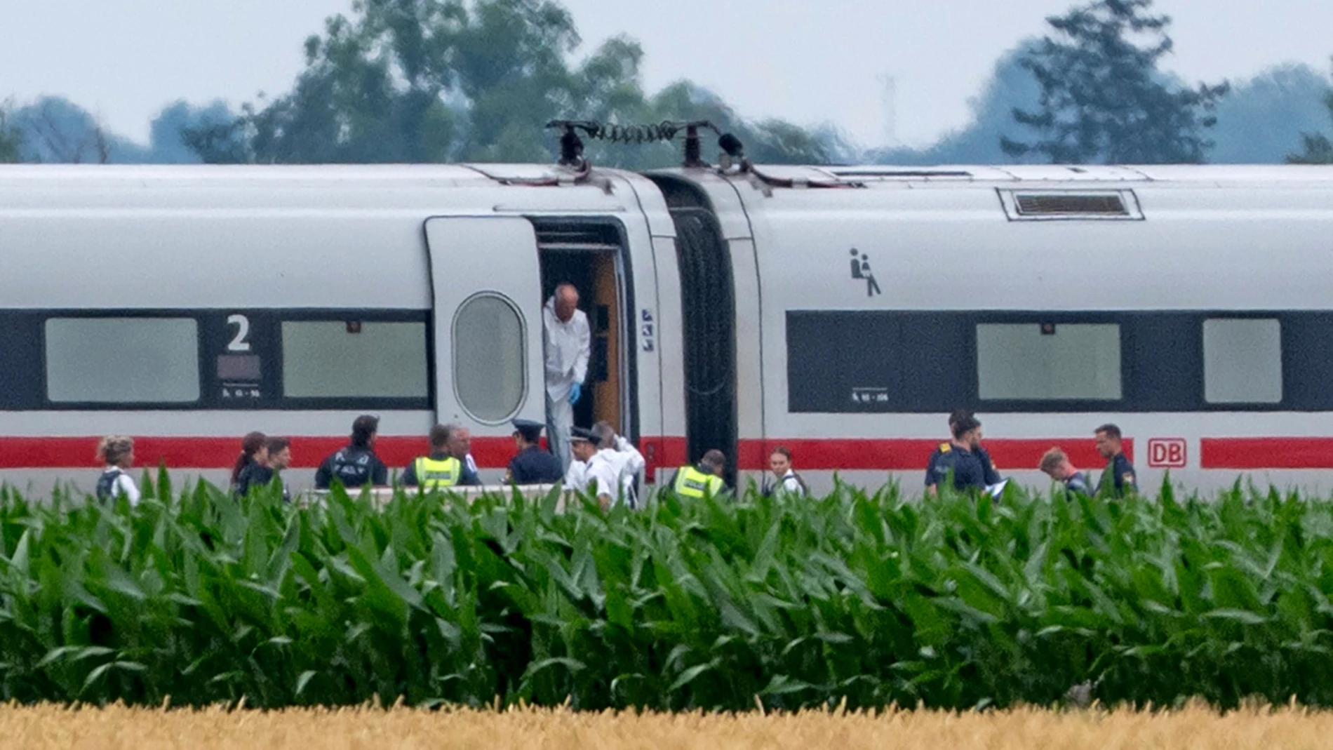 Police and forensics are investigating an ICE train in which a man attacked several passengers in Strasskirchen, Germany, Thurdsday, July 3, 2025. (Armin Weigel/dpa via AP)