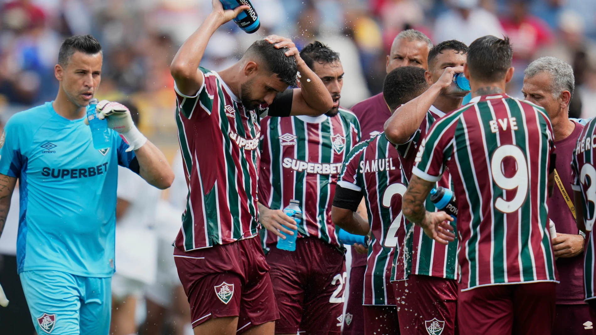 Fluminense players cooling up during a water break at the Club World Cup quarterfinal soccer match between Fluminense and Al Hilal in Orlando, Fla., Friday, July 4, 2025. (AP Photo/John Raoux)