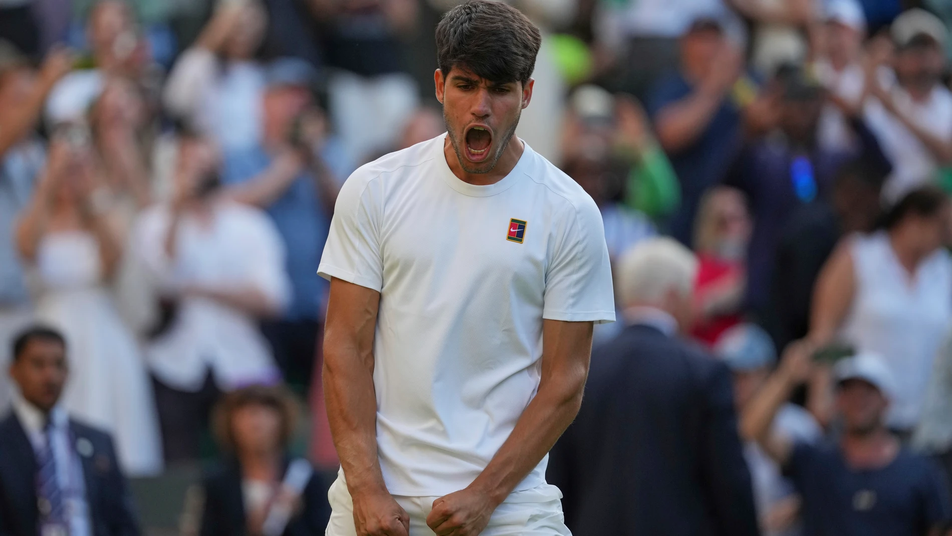 Carlos Alcaraz of Spain celebrates after beating Jan-Lennard Struff of Germany during a third round men's singles match at the Wimbledon Tennis Championships in London, Friday, July 4, 2025. (AP Photo/Kin Cheung)