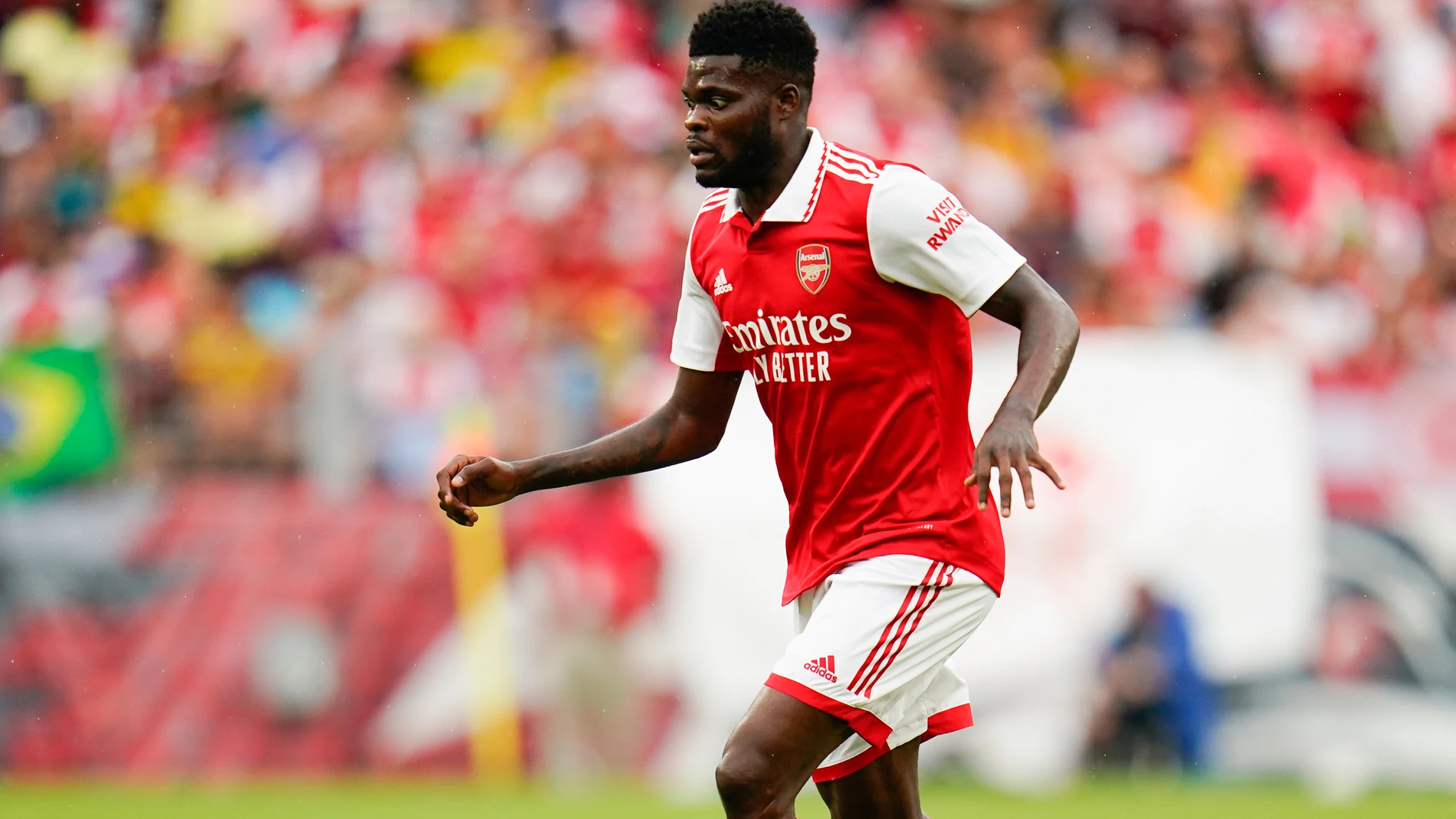FILE - Arsenal midfielder Thomas Partey runs with the ball against Everton during the first half of a pre-season friendly soccer match, Saturday, July 16, 2022, in Baltimore. (AP Photo/Julio Cortez, File)