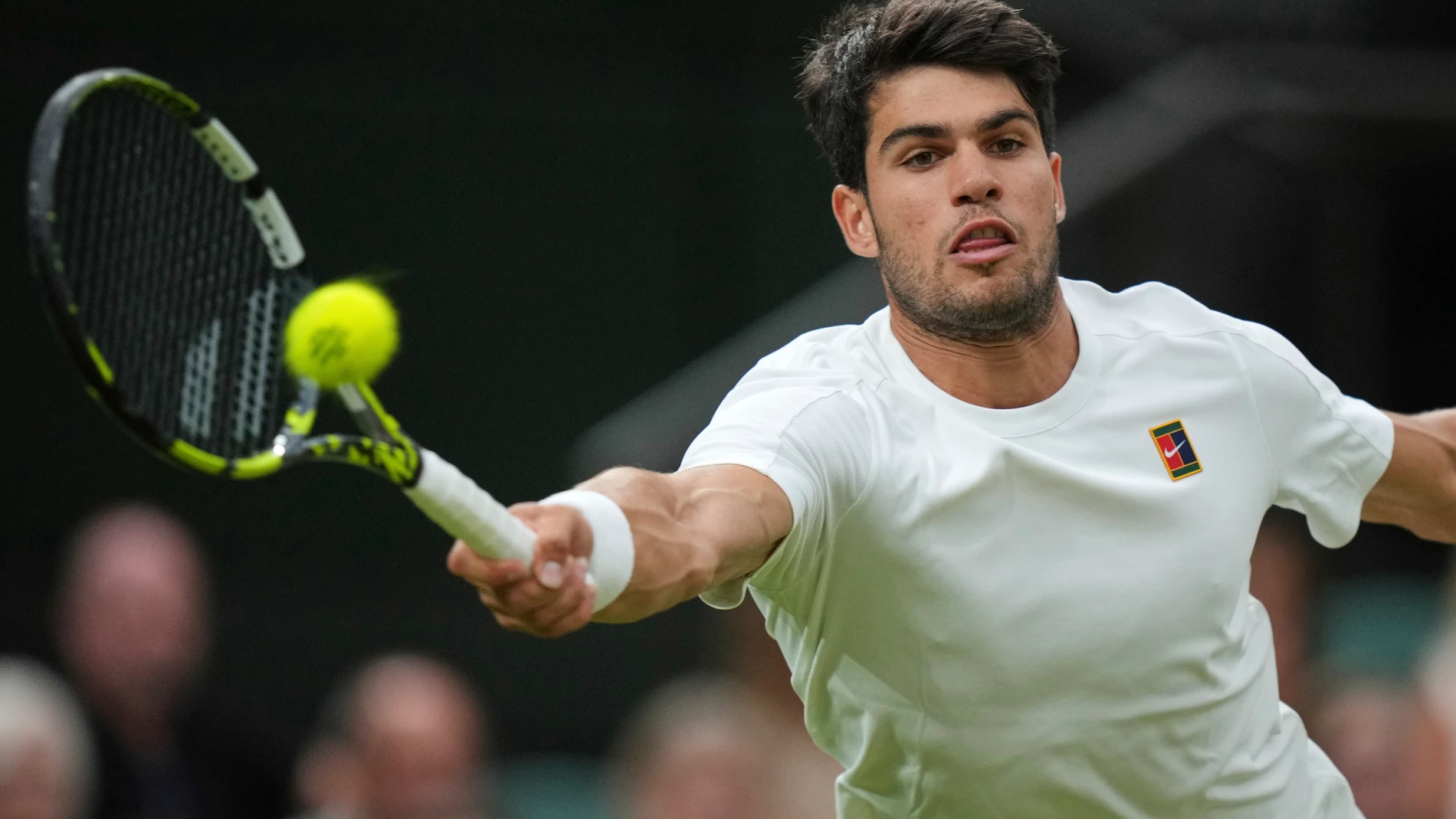 Spain's Carlos Alcaraz returns to Russia's Andrey Rublev during a fourth round men's singles match at the Wimbledon Tennis Championships in London, Sunday, July 6, 2025. (AP Photo/Alastair Grant)