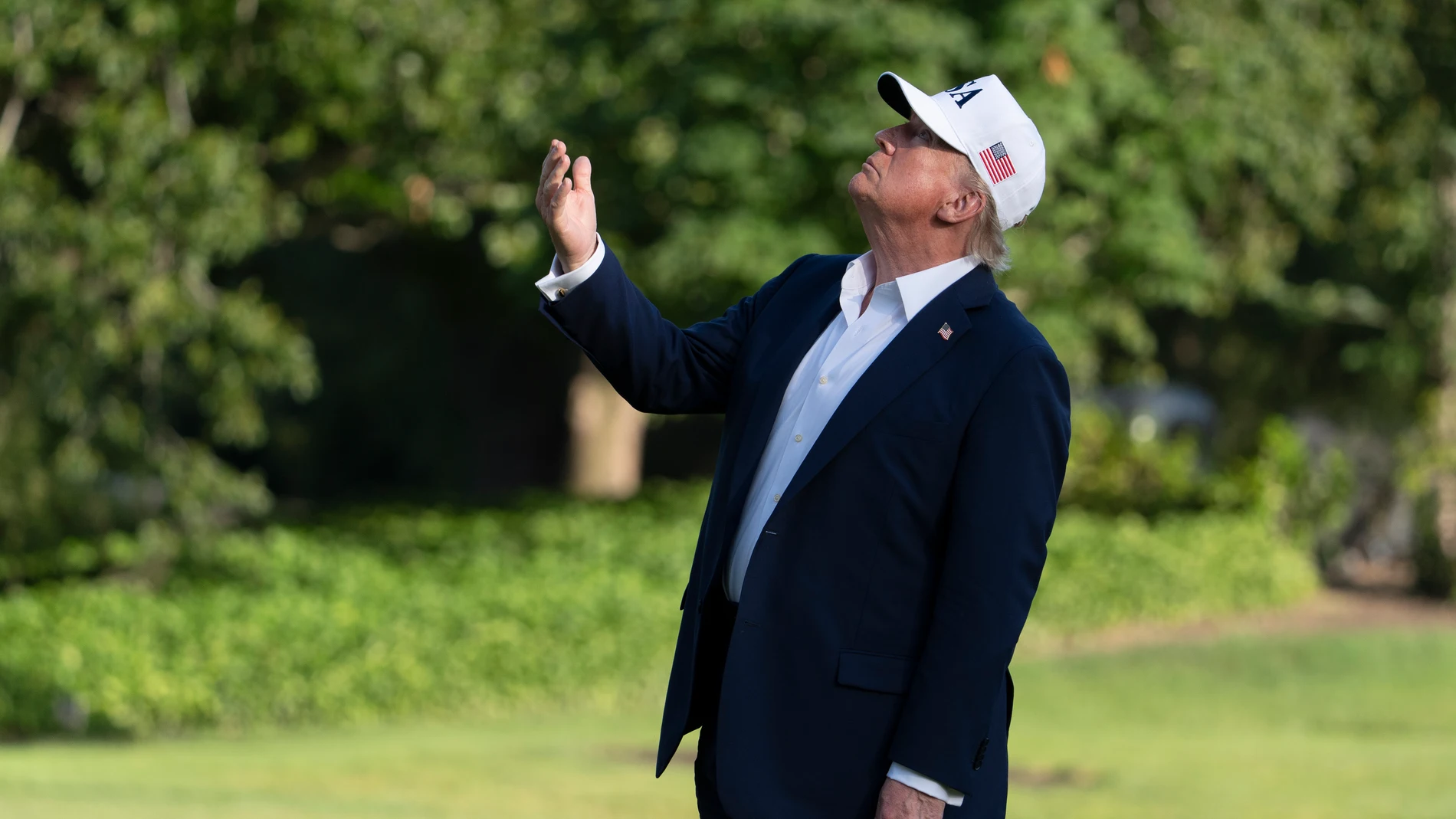 President Donald Trump looks up at the American flag on the flagpole on the South Lawn as he arrives at the White House, Sunday, July 6, 2025, in Washington. (AP Photo/Manuel Balce Ceneta)