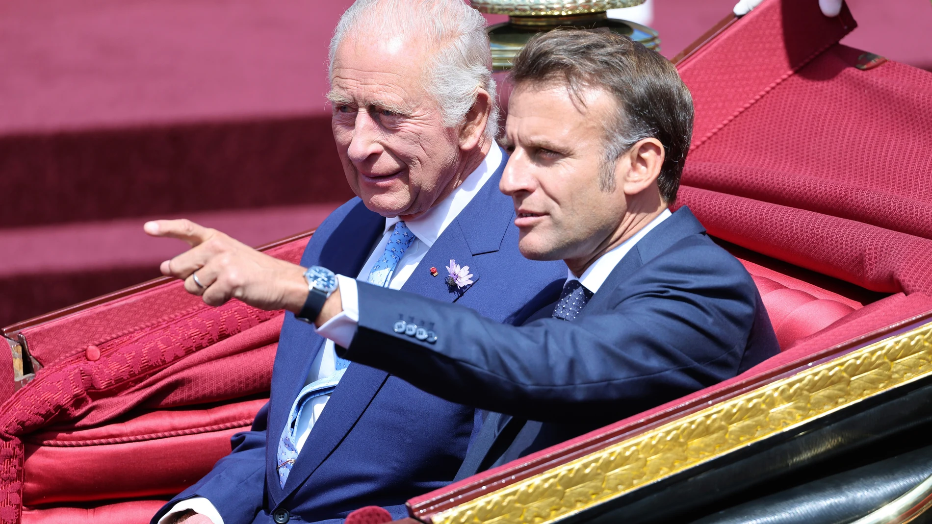 Britain's King Charles III and France's President Emmanuel Macron, right, travel in a 1902 State Landau on a state drive to Windsor Castle in Windsor, England, Tuesday July 8, 2025, on the first day of a three-day state visit to Britain. (Chris Jackson/Pool via AP)
