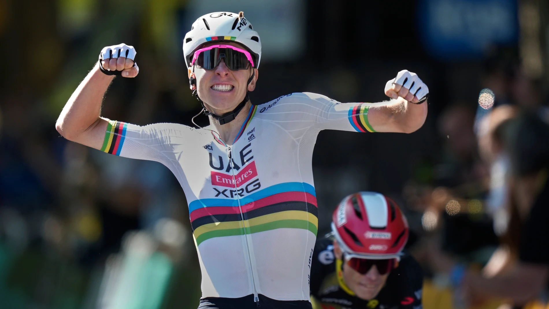 Slovenia's Tadej Pogacar, right, celebrates as he crosses the finish line to win the fourth stage of the Tour de France cycling race over 172.2 kilometers (107 miles) with start in Amiens and finish in Rouen, France, Tuesday, July 8, 2025. (AP Photo/Mosa'ab Elshamy))