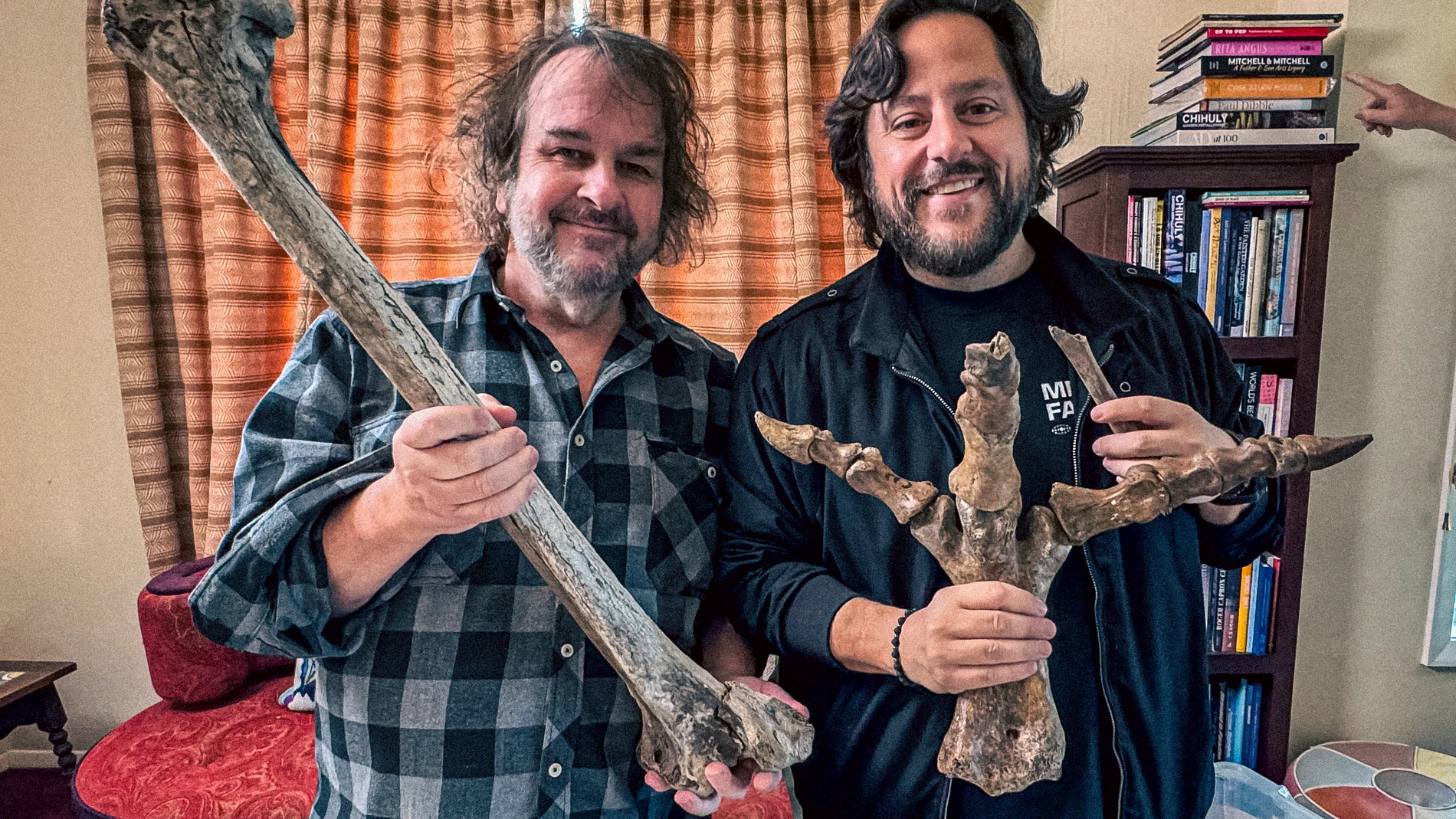 Filmmaker Peter Jackson, left, and Colossal CEO Ben Lamm hold up bones from Jackson's collection of extinct moa bones in Wellington, New Zealand, 2024. (Courtesy of Colossal Biosciences via AP)