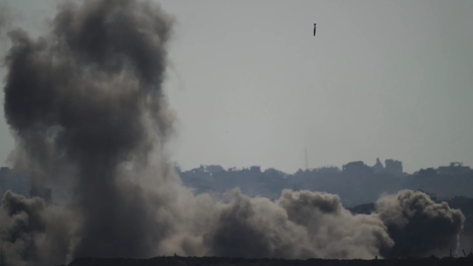 A projectile is visible in the sky as smoke rises during an Israeli bombardment in the northern Gaza Strip, as seen from southern Israel, Tuesday, July 8, 2025. (AP Photo/Leo Correa)