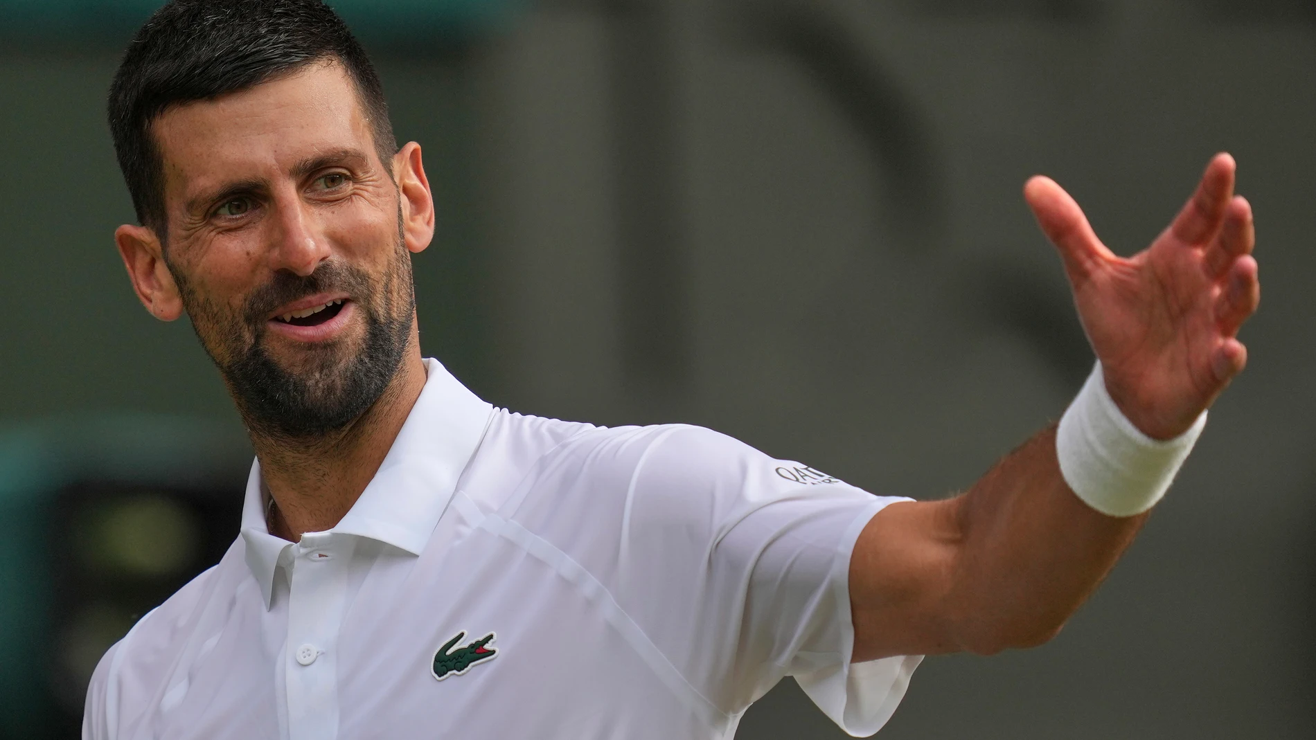 Serbia's Novak Djokovic gestures as he plays Italy's Flavio Cobolli during a quarterfinal men's singles match at the Wimbledon Tennis Championships in London, Wednesday, July 9, 2025. (AP Photo/Kin Cheung)