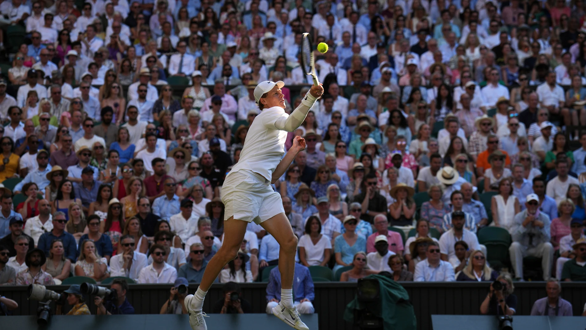 Italy's Jannik Sinner returns to Serbia's Novak Djokovic in a men's singles semifinal at the Wimbledon Tennis Championships in London, Friday, July 11, 2025. (AP Photo/Kin Cheung)