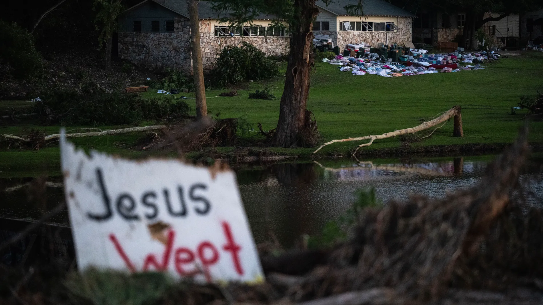 FILE - Camper's belongings sit outside one of Camp Mystic's cabins near the Guadalupe River after a flash flood swept through the area Monday, July 7, 2025, in Hunt, Texas. (AP Photo/Eli Hartman, File)