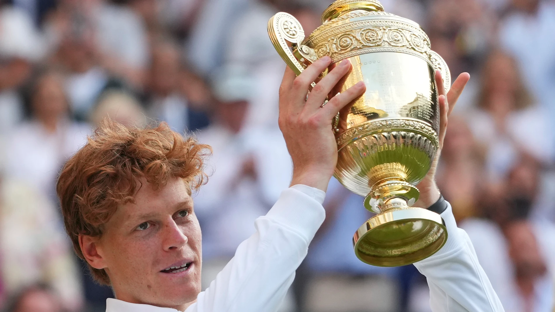 Jannik Sinner of Italy holds the trophy after winning the men's singles final match against Carlos Alcaraz of Spain at the Wimbledon Tennis Championships in London, Sunday, July 13, 2025.(AP Photo/Kirsty Wigglesworth)