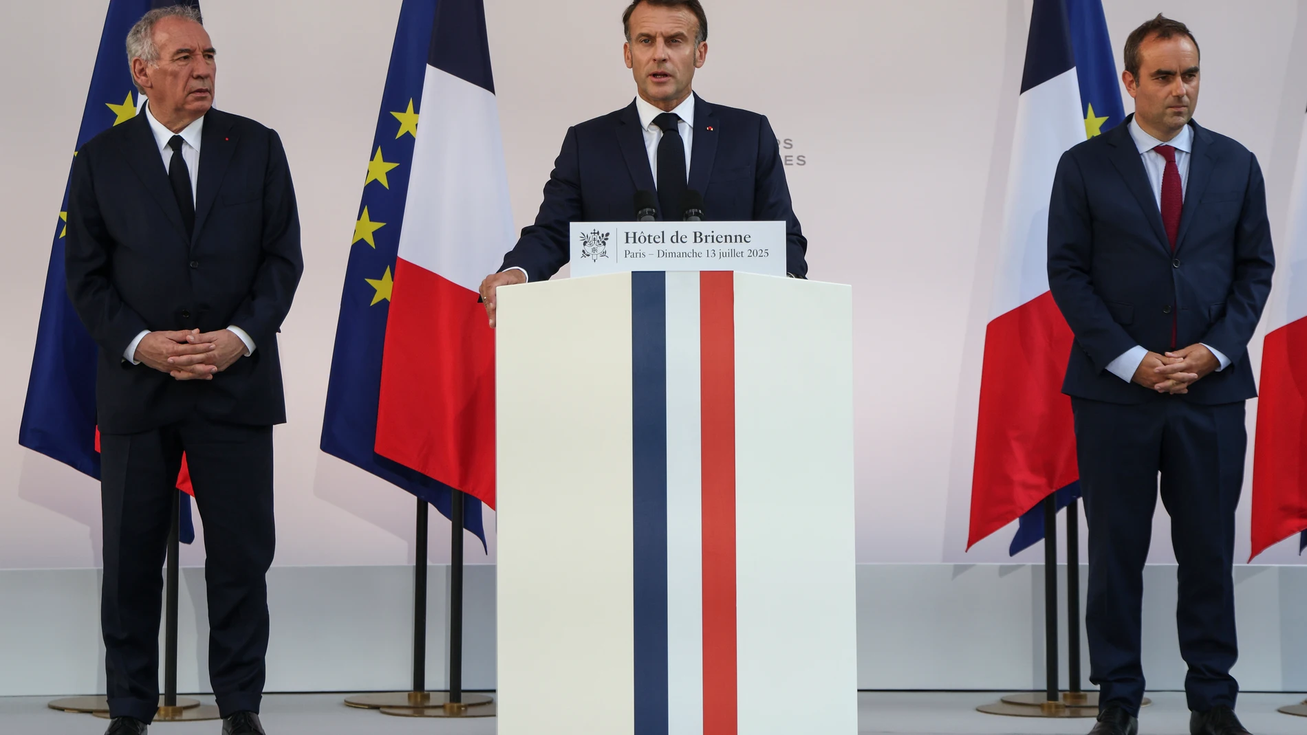 French President Emmanuel Macron speaks to the army leaders flanked by Prime Minister Francois Bayrou, left, and Defense Minister Sebastien Lecornu at the Hotel le Brienne, Sunday, July 13, 2025, ahead of the Bastille Day parade in Paris. (Ludovic Marin, Pool Photo via AP)
