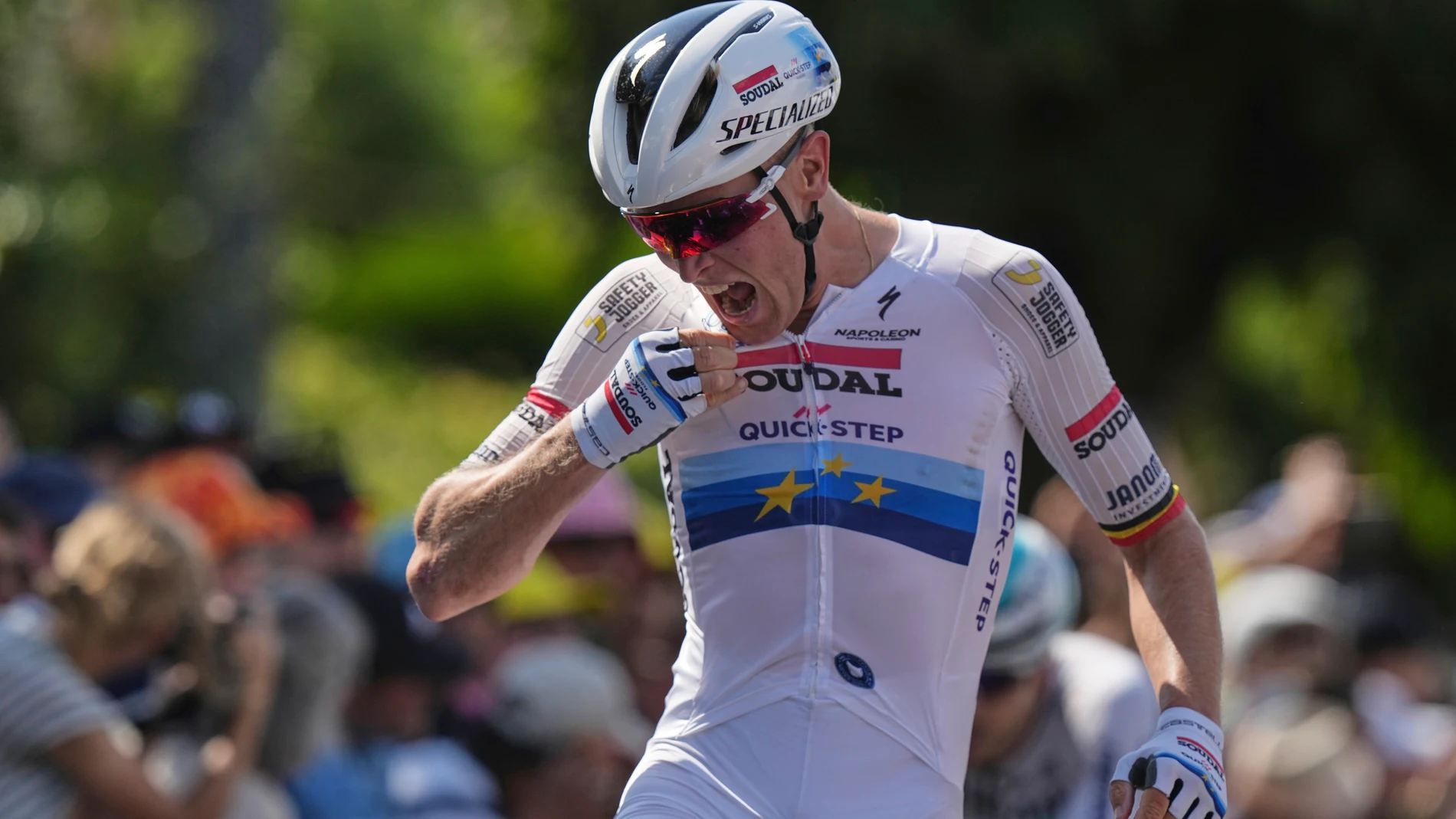Stage winner Belgium's Tim Merlier celebrates as he crosses the finish line of the ninth stage of the Tour de France cycling race over 174.1 kilometers (108 miles) with start in Chinon and finish in Chateauroux, France, Sunday, July 13, 2025. (AP Photo/Thibault Camus)