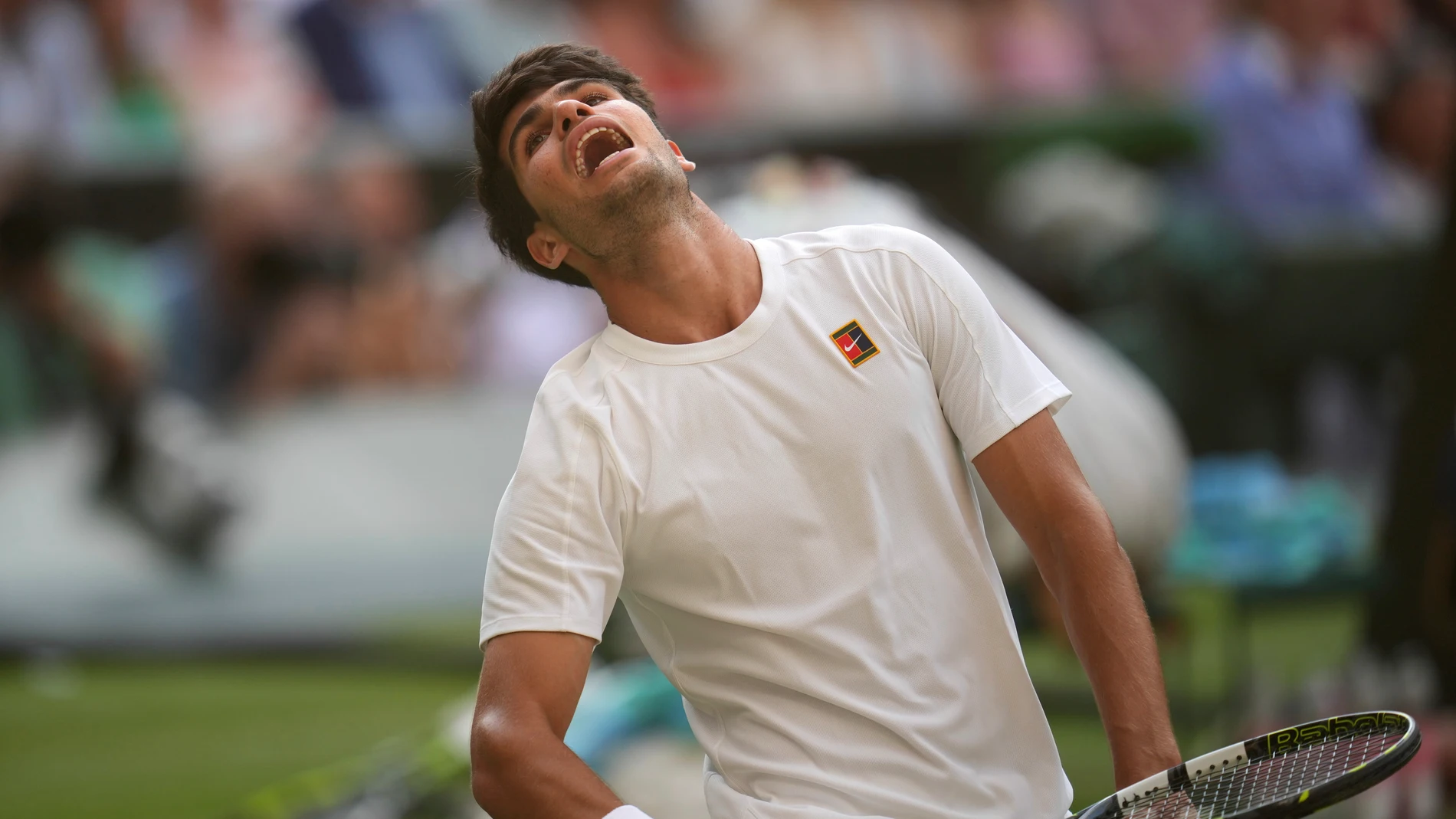 Carlos Alcaraz of Spain reacts after losing a point to Italy's Jannik Sinner in the men's singles final at the Wimbledon Tennis Championships in London, Sunday, July 13, 2025. (AP Photo/Kin Cheung)