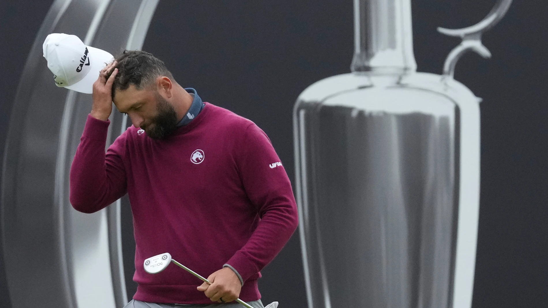 Jon Rahm of Spain reacts after putting on the 18th green during the second round of the British Open golf championship at the Royal Portrush Golf Club, Northern Ireland, Friday, July 18, 2025. (AP Photo/Jon Super)