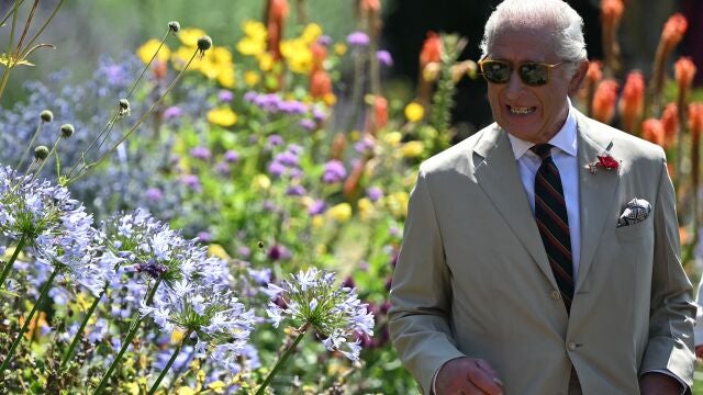 Britain's King Charles III smiles during a visit to a community garden, the historic walled garden at Deal Castle, known as the Captain's Garden , in Deal, south-east England on July 10, 2025. 